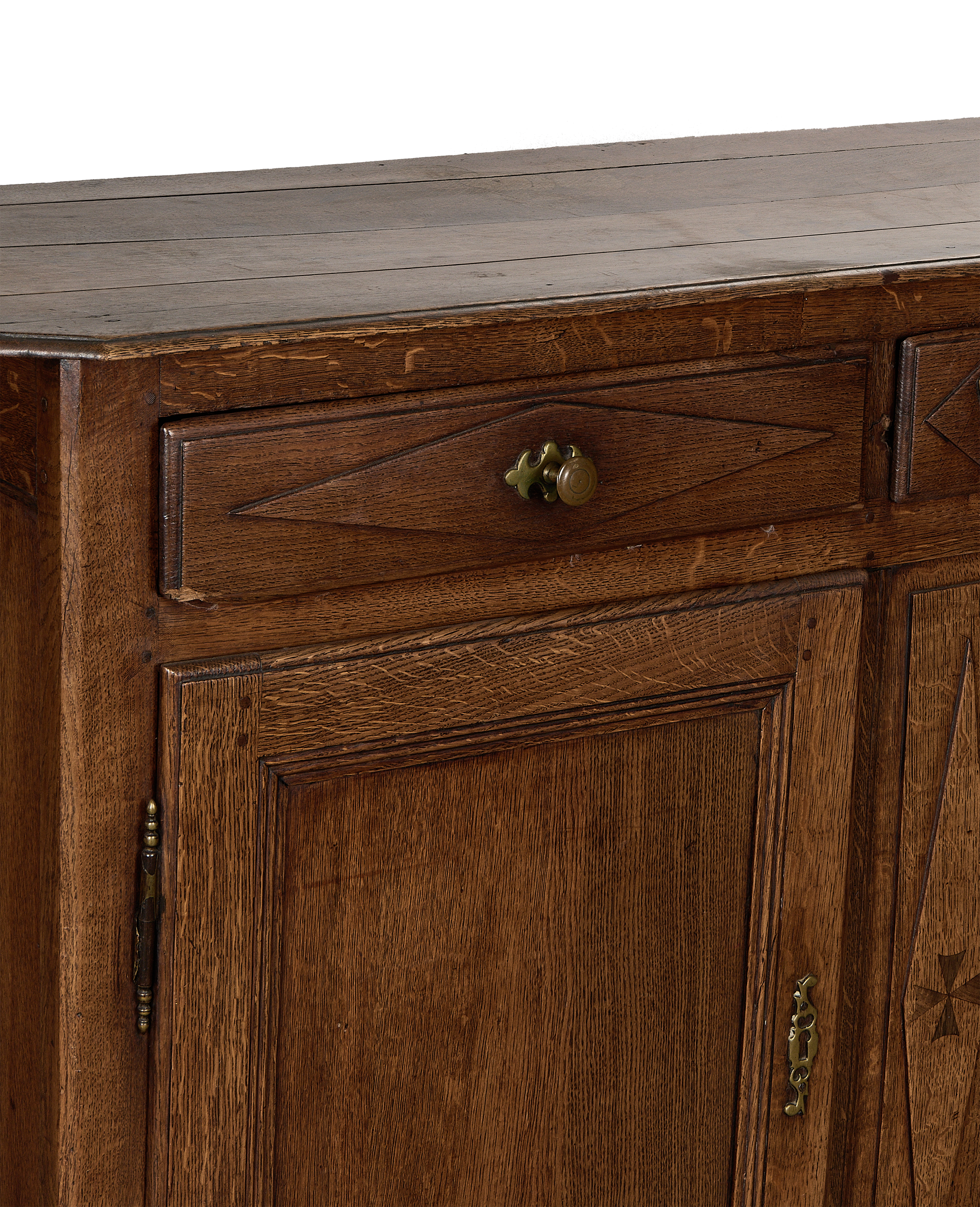 Close-up of vintage French oak dresser showing drawer with brass pull detail.