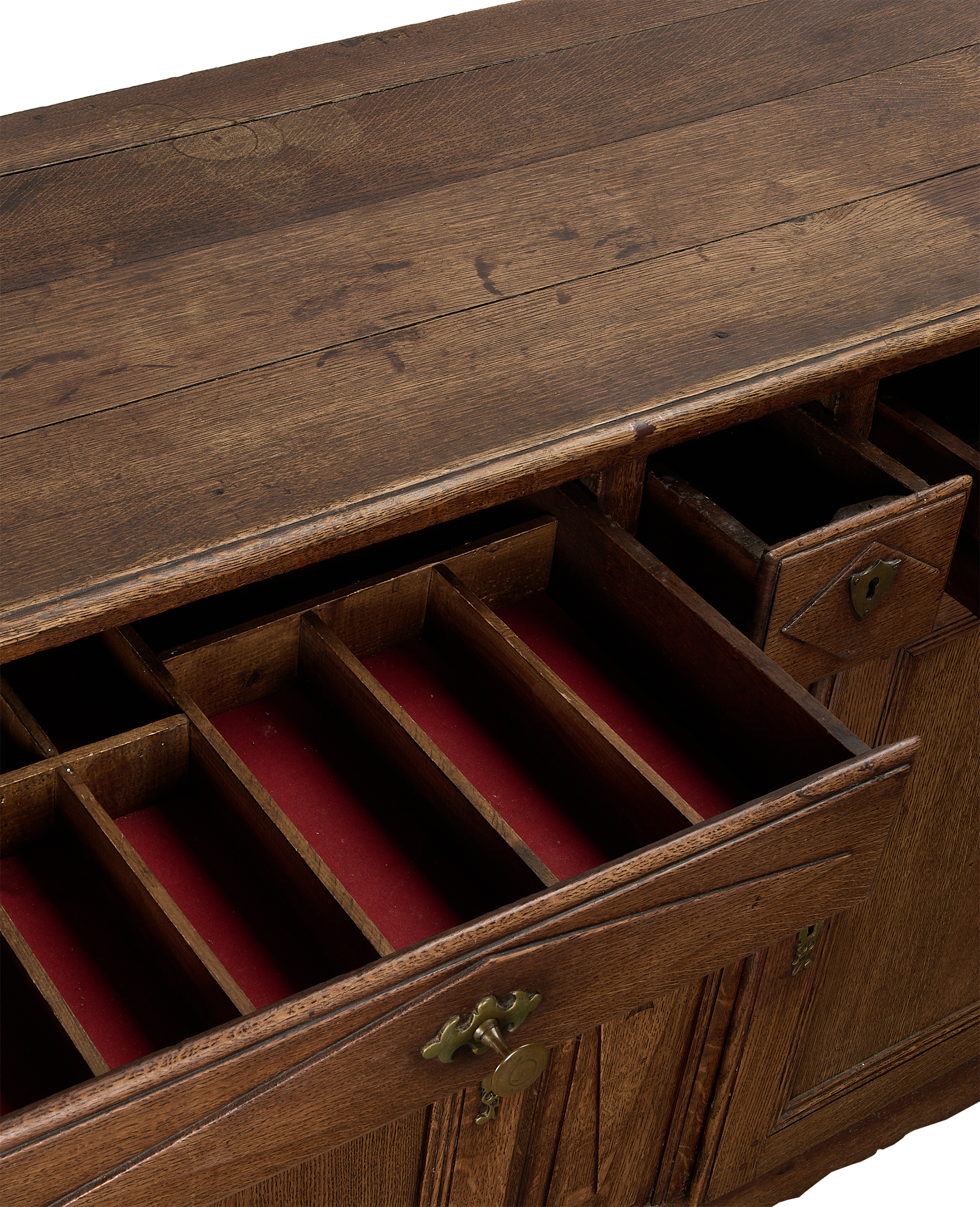 Vintage French oak dresser with open drawers showing red velvet lining and dividers.