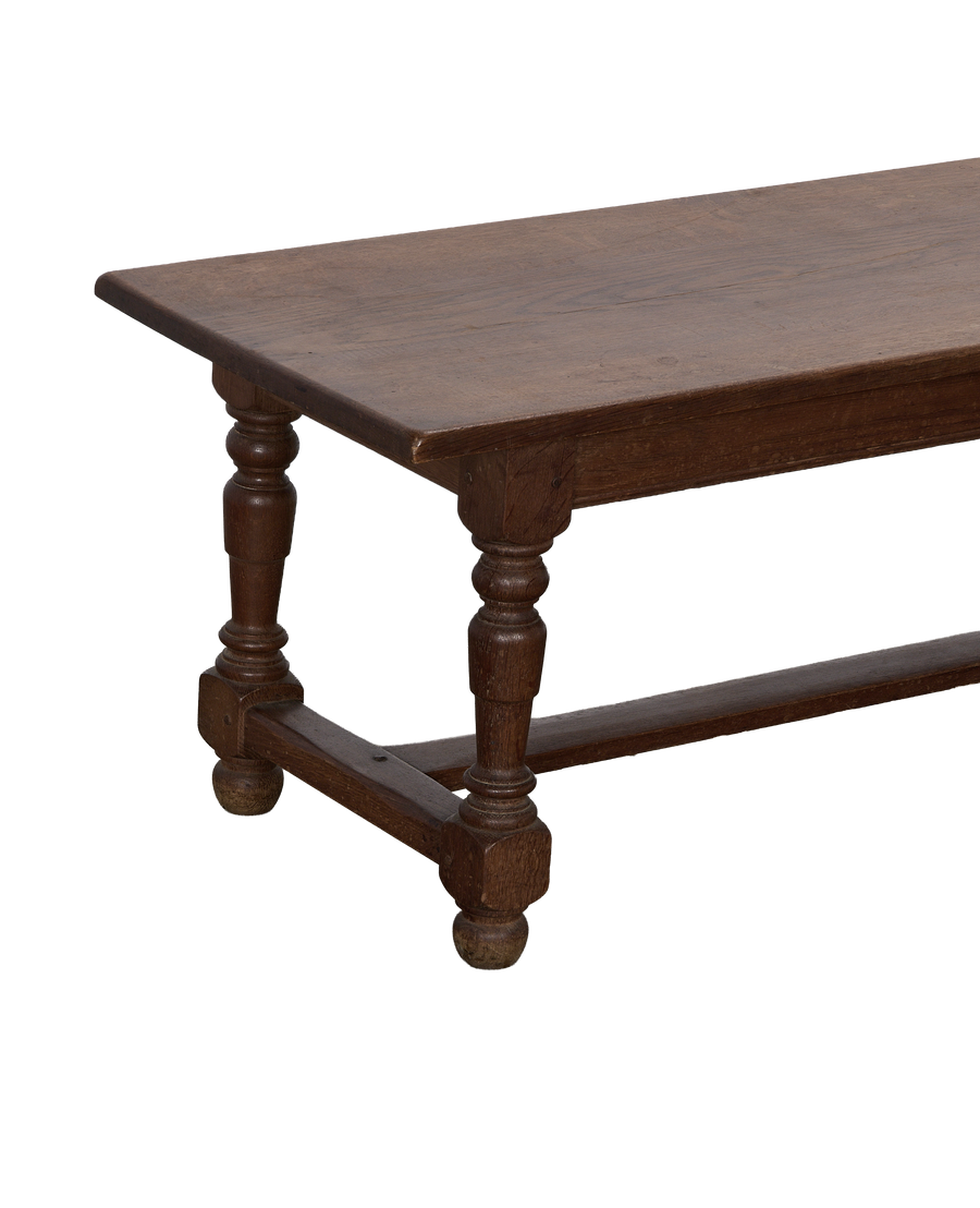 Vintage French oak coffee table, showcasing a turned leg and stretcher detail.