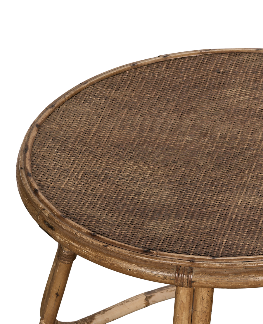Vintage French bamboo coffee table, close-up of natural cane woven tabletop texture.