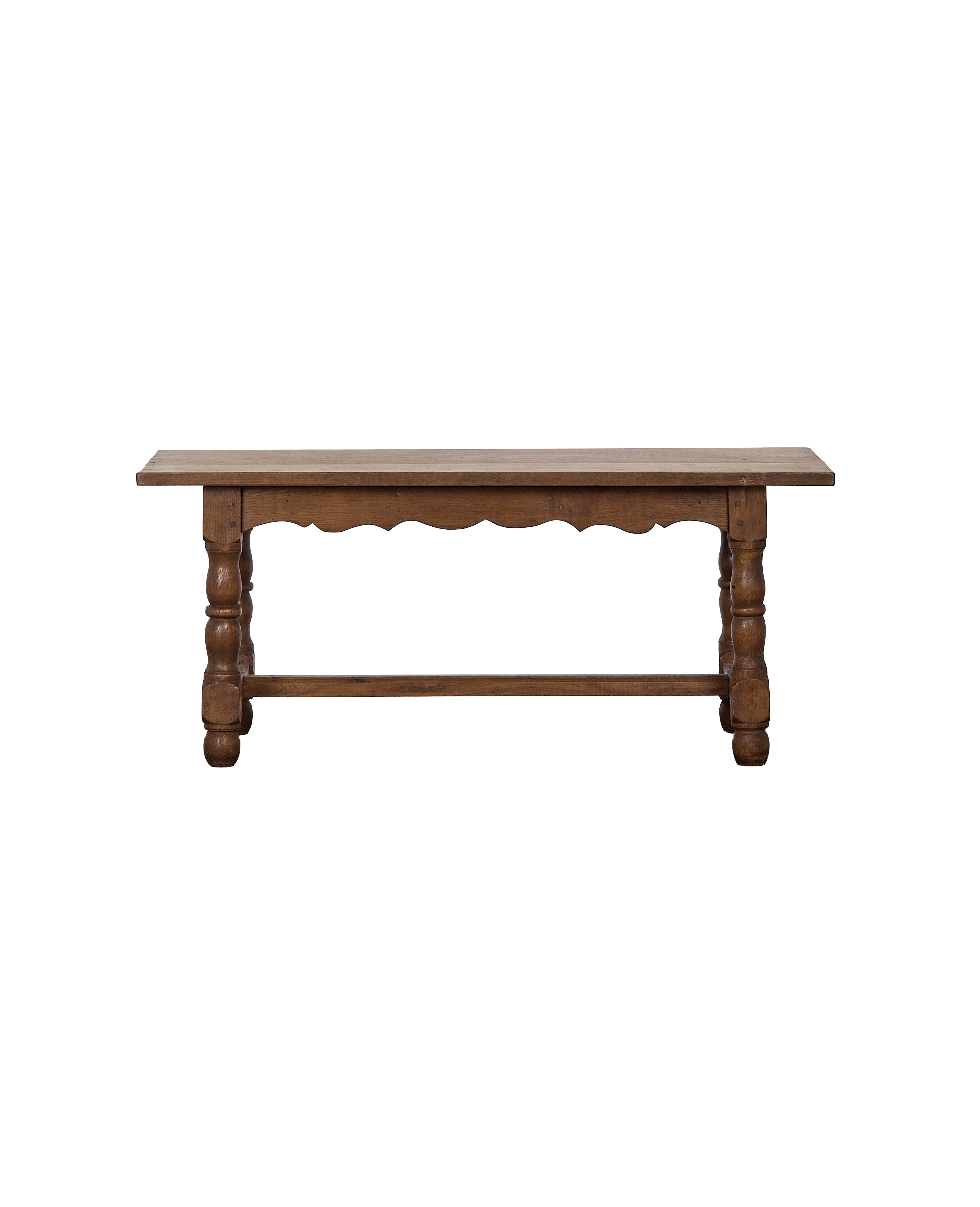 Vintage French oak coffee table, front view displaying carved legs and scalloped skirt.