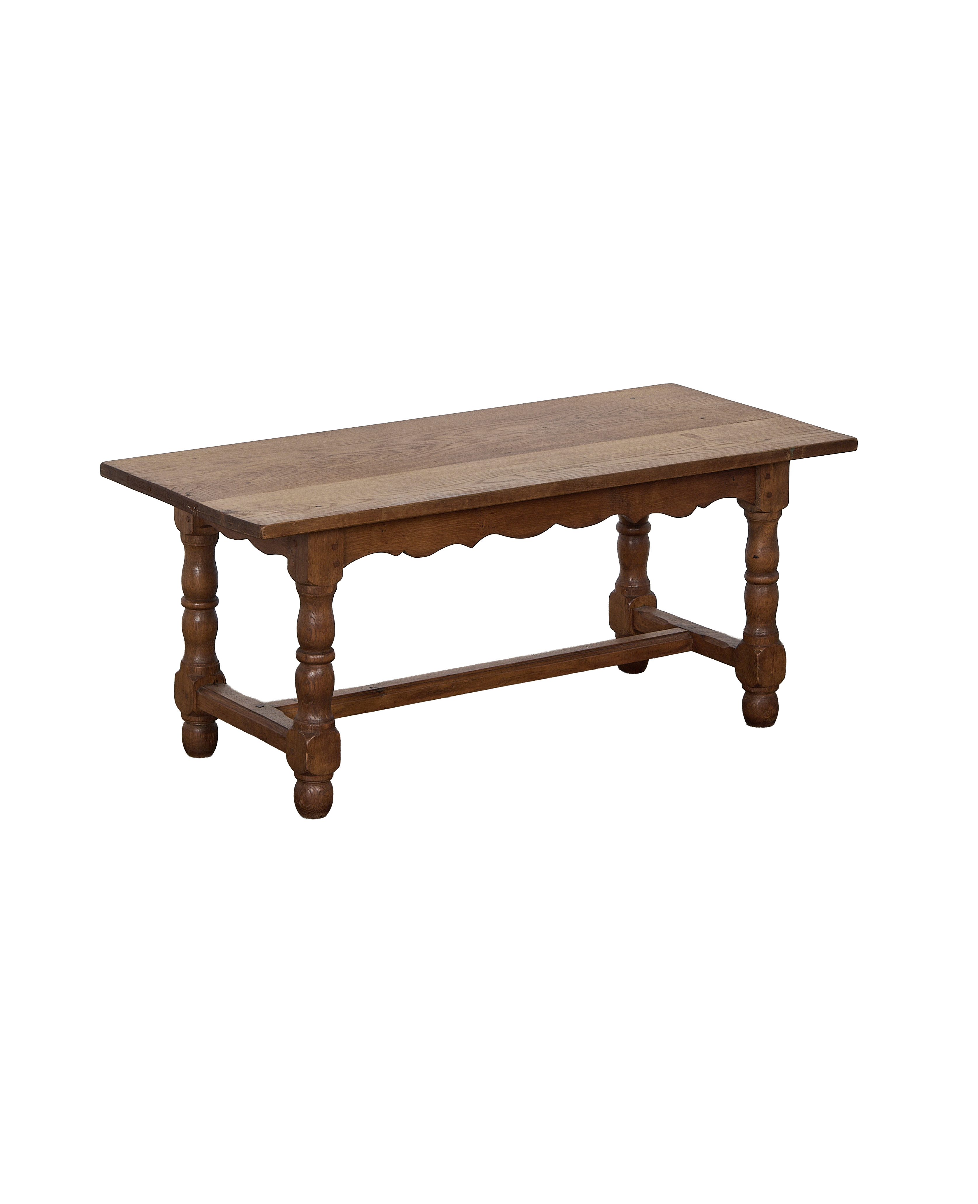Vintage French oak coffee table with ornate carved apron and turned legs, from France.