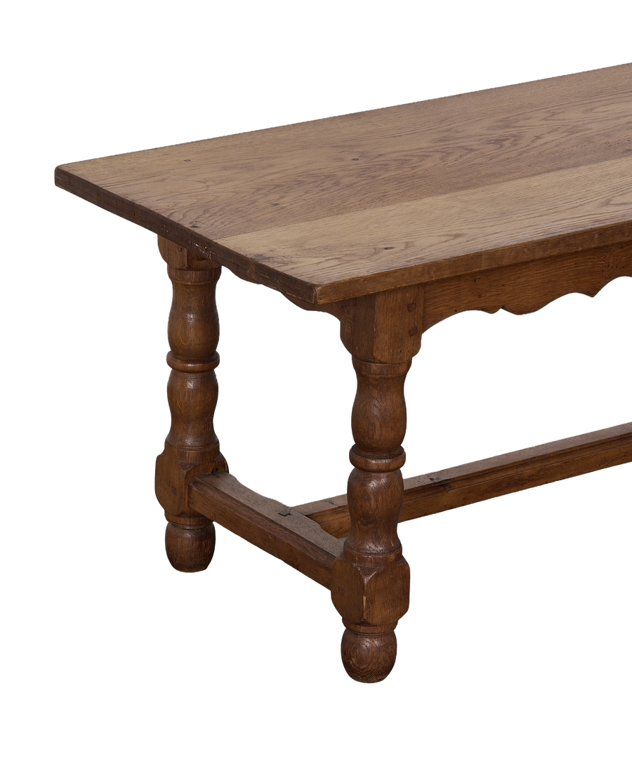 Vintage French oak coffee table, showcasing tabletop planks and decorative turned legs.