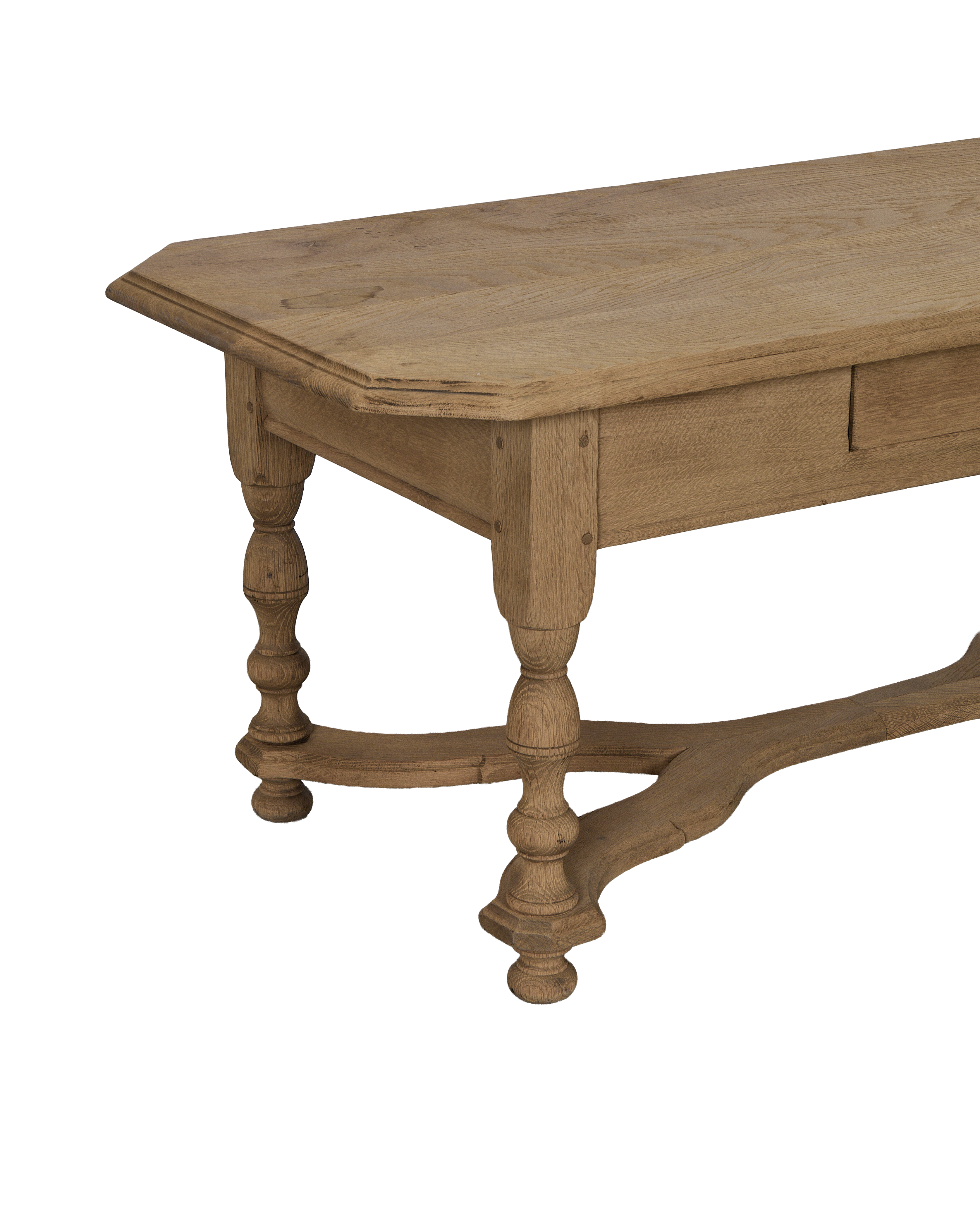 Vintage French oak coffee table showcasing turned legs, stretcher base, and distressed wood texture.