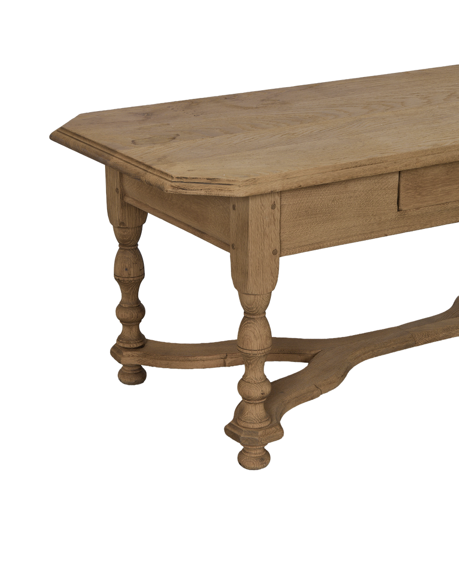 Vintage French oak coffee table showcasing turned legs, stretcher base, and distressed wood texture.