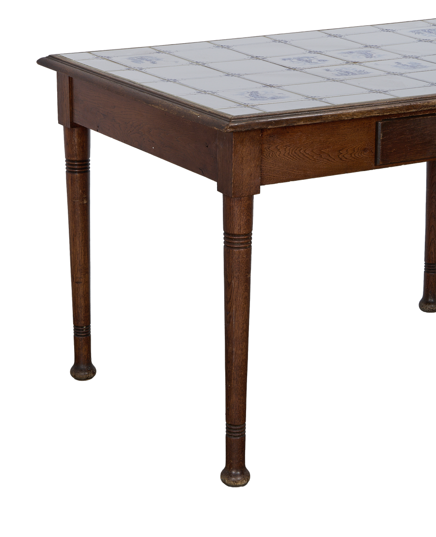 Vintage French oak Delft table with intricate blue and white tiled top.