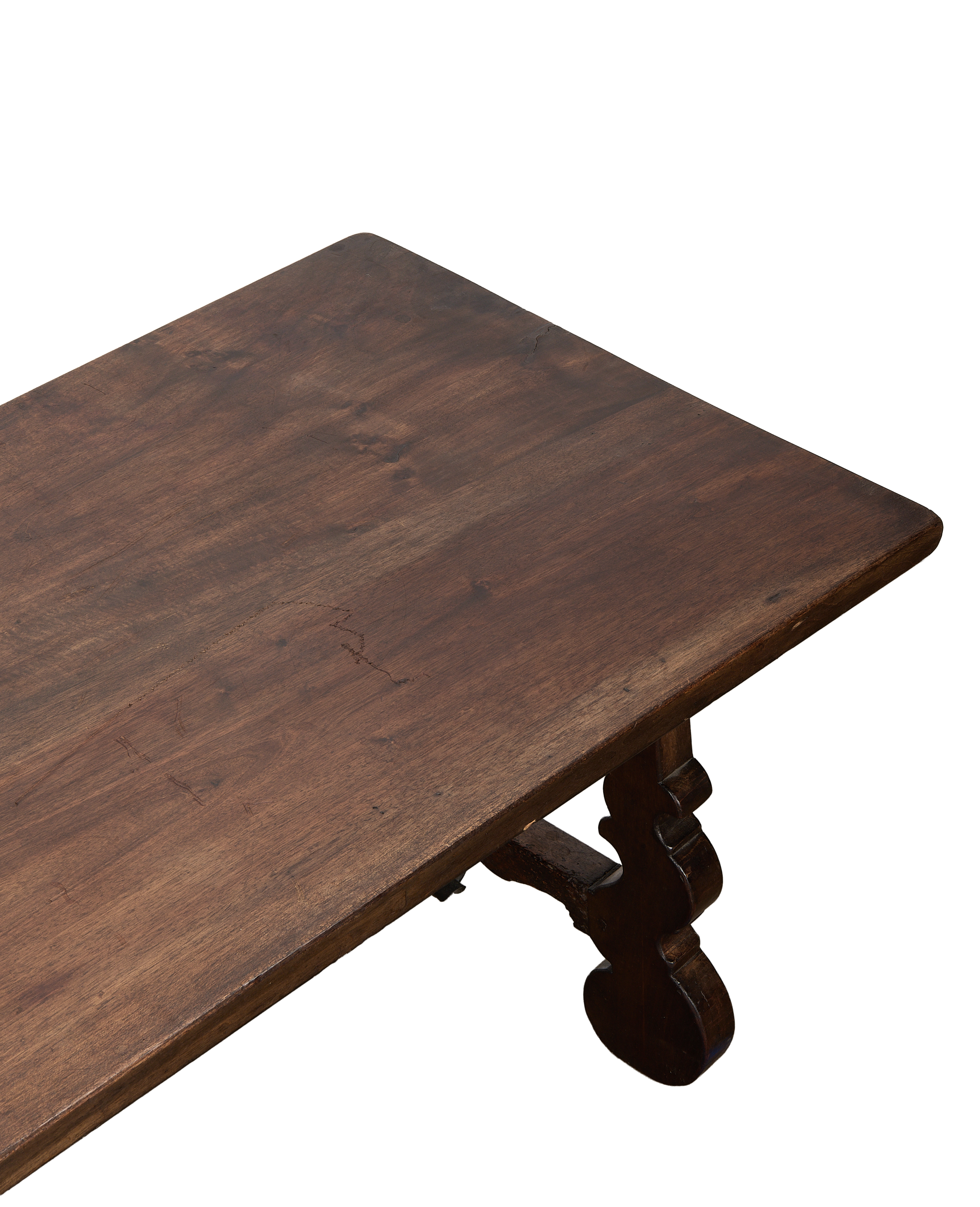 Vintage French oak refectory coffee table top, showing distressed wood grain and curved leg detail.