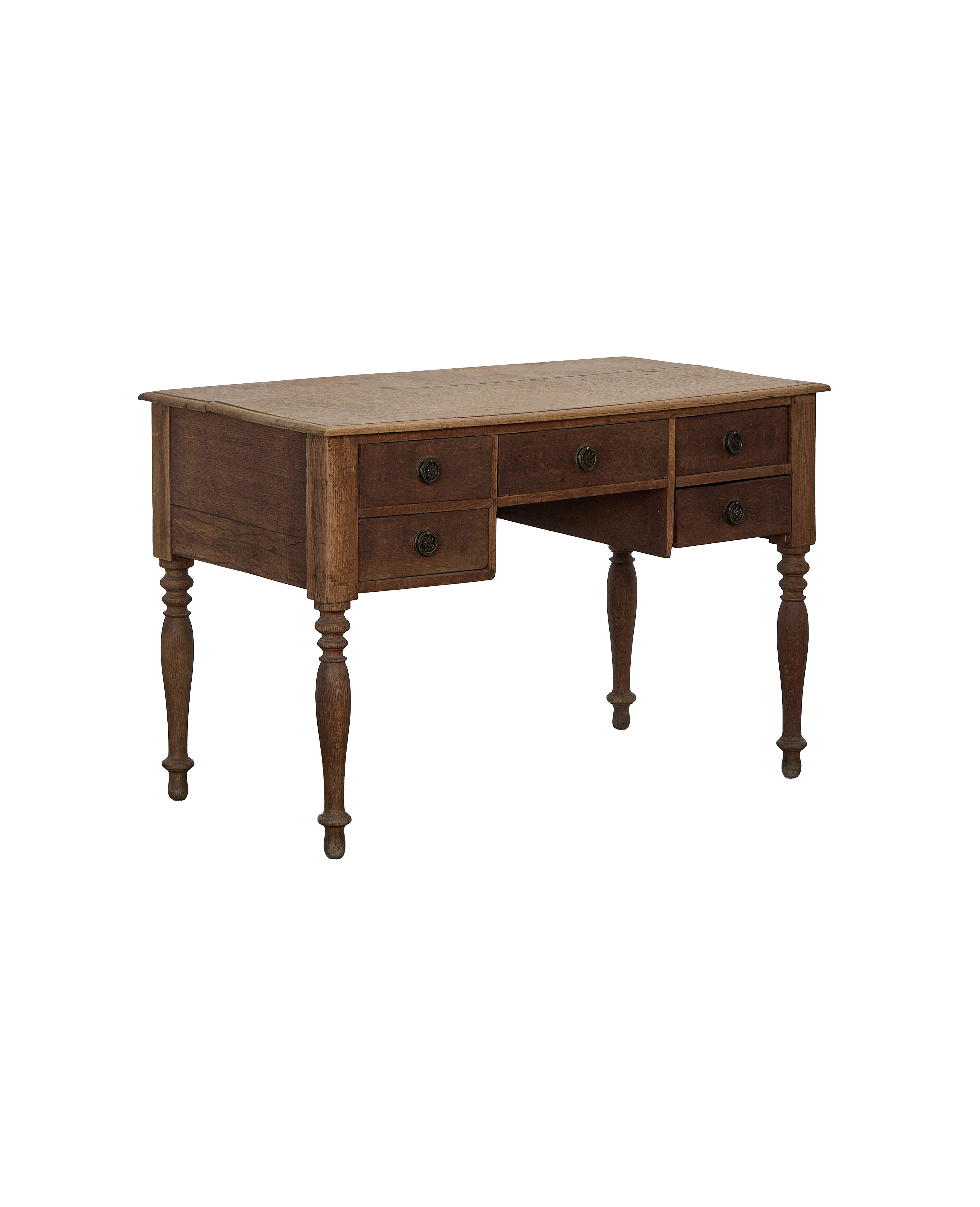 Vintage French oak desk, showing drawers with decorative pulls and turned legs.