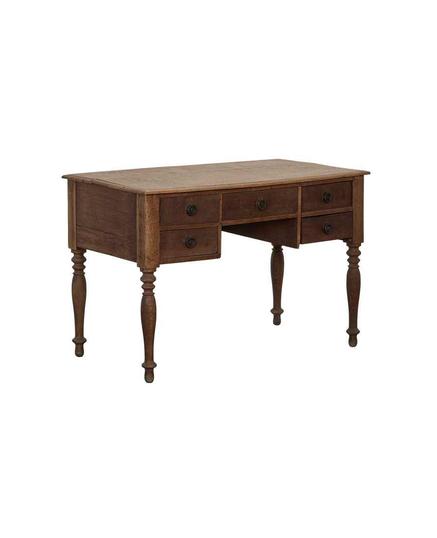 Vintage French oak desk, showing drawers with decorative pulls and turned legs.