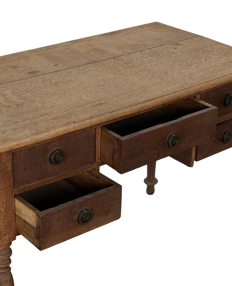Vintage French oak wood desk, two drawers open showing construction and aged brass pulls.