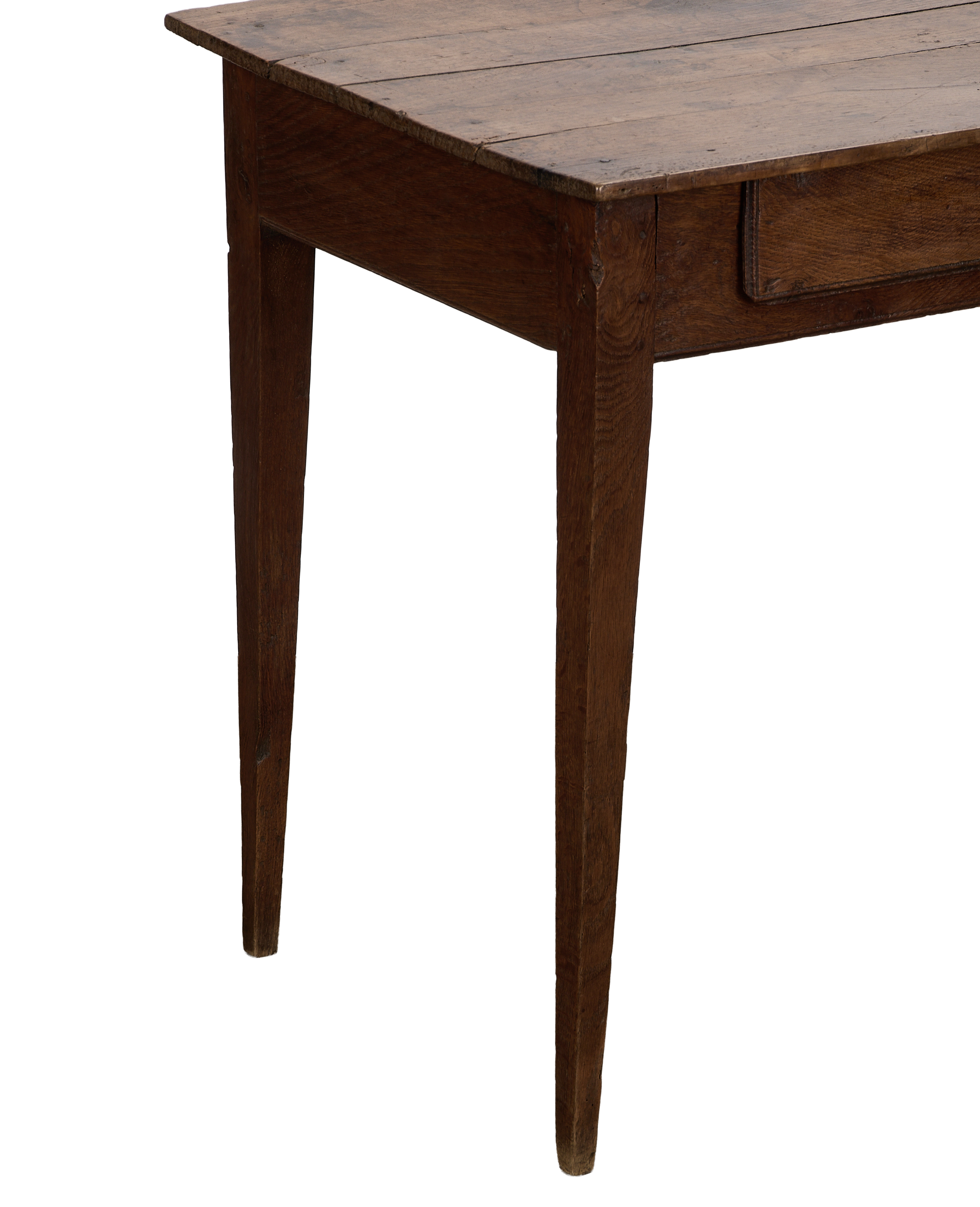 Vintage French oak wood desk showcasing its drawer and tapered legs from an angled perspective.