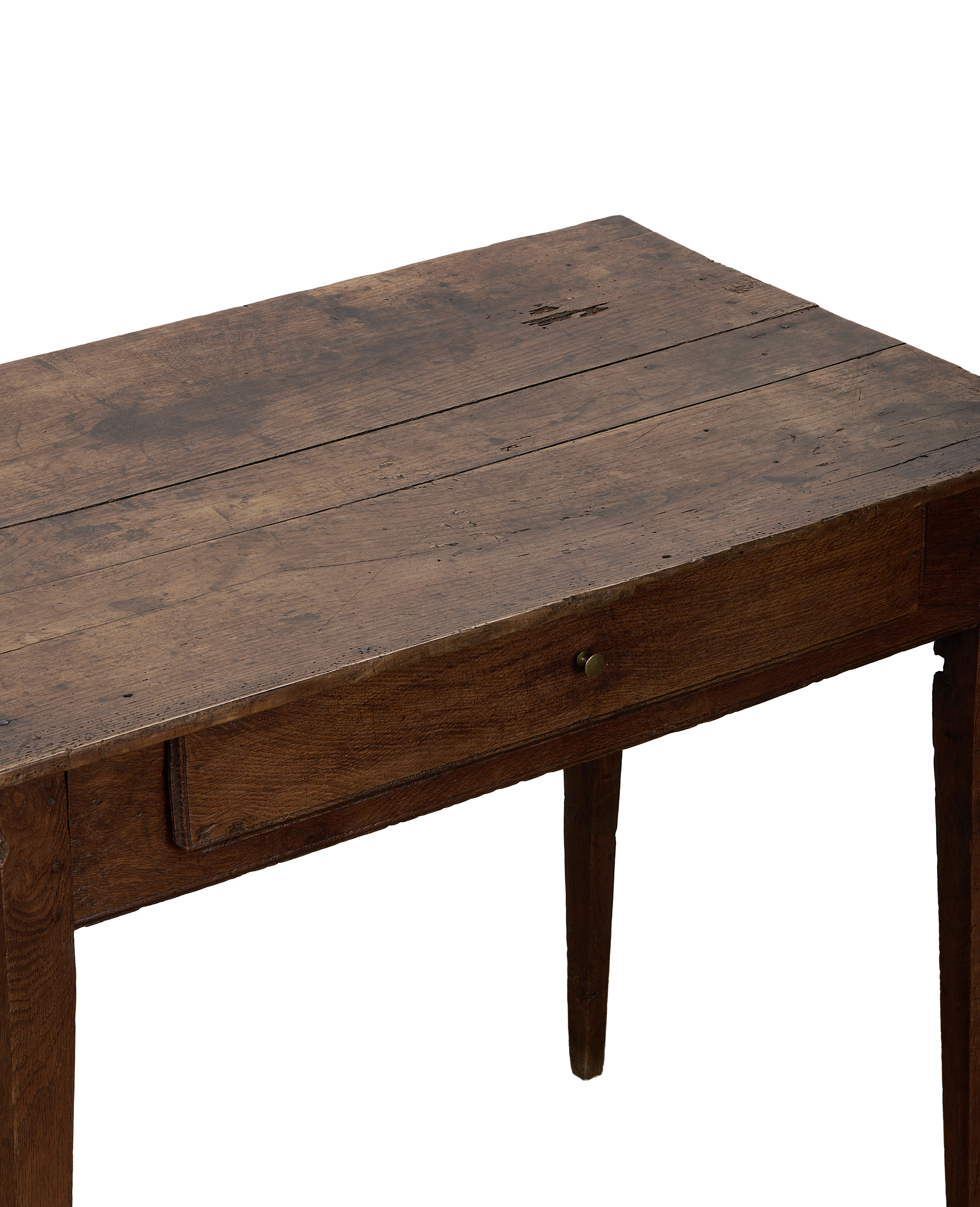 Vintage French oak wooden desk, showing distressed tabletop, single drawer, and tapered leg.