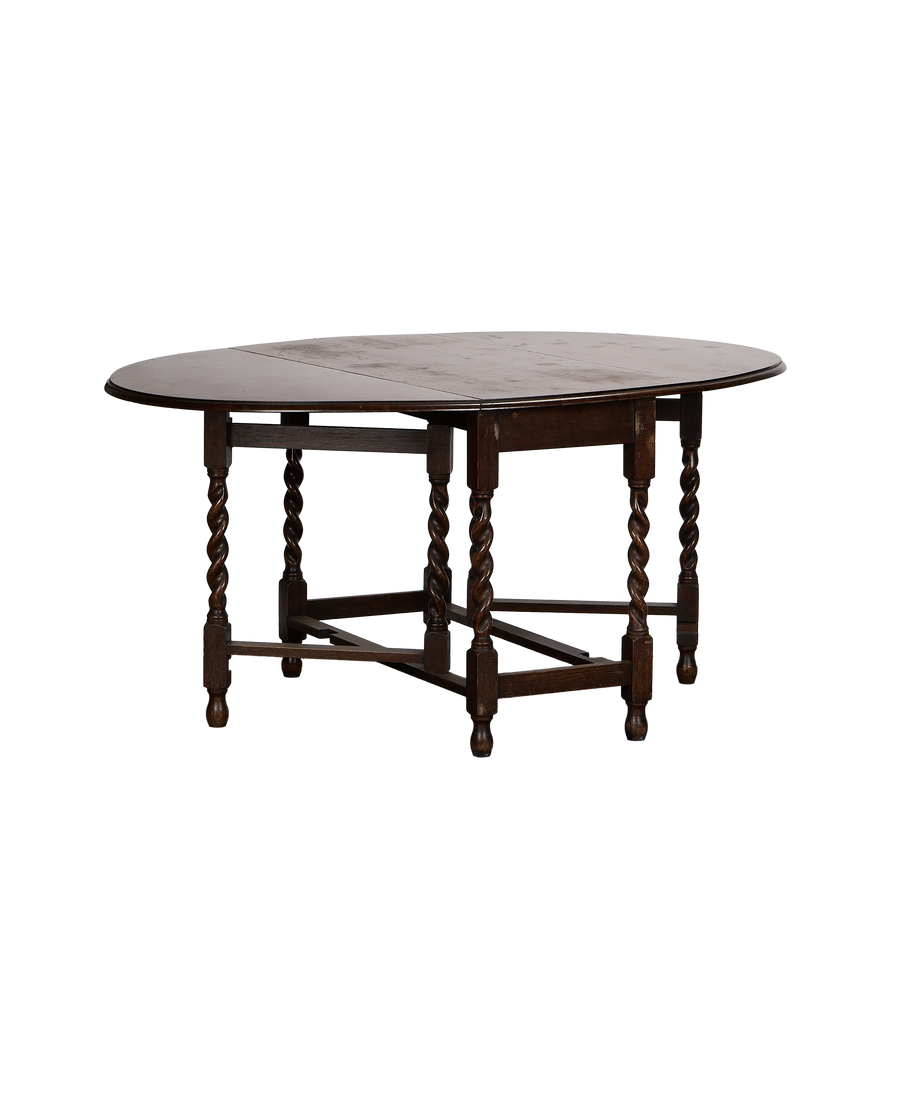 Vintage French oak gate leg table, closed oval top, with twisted barley-twist legs.