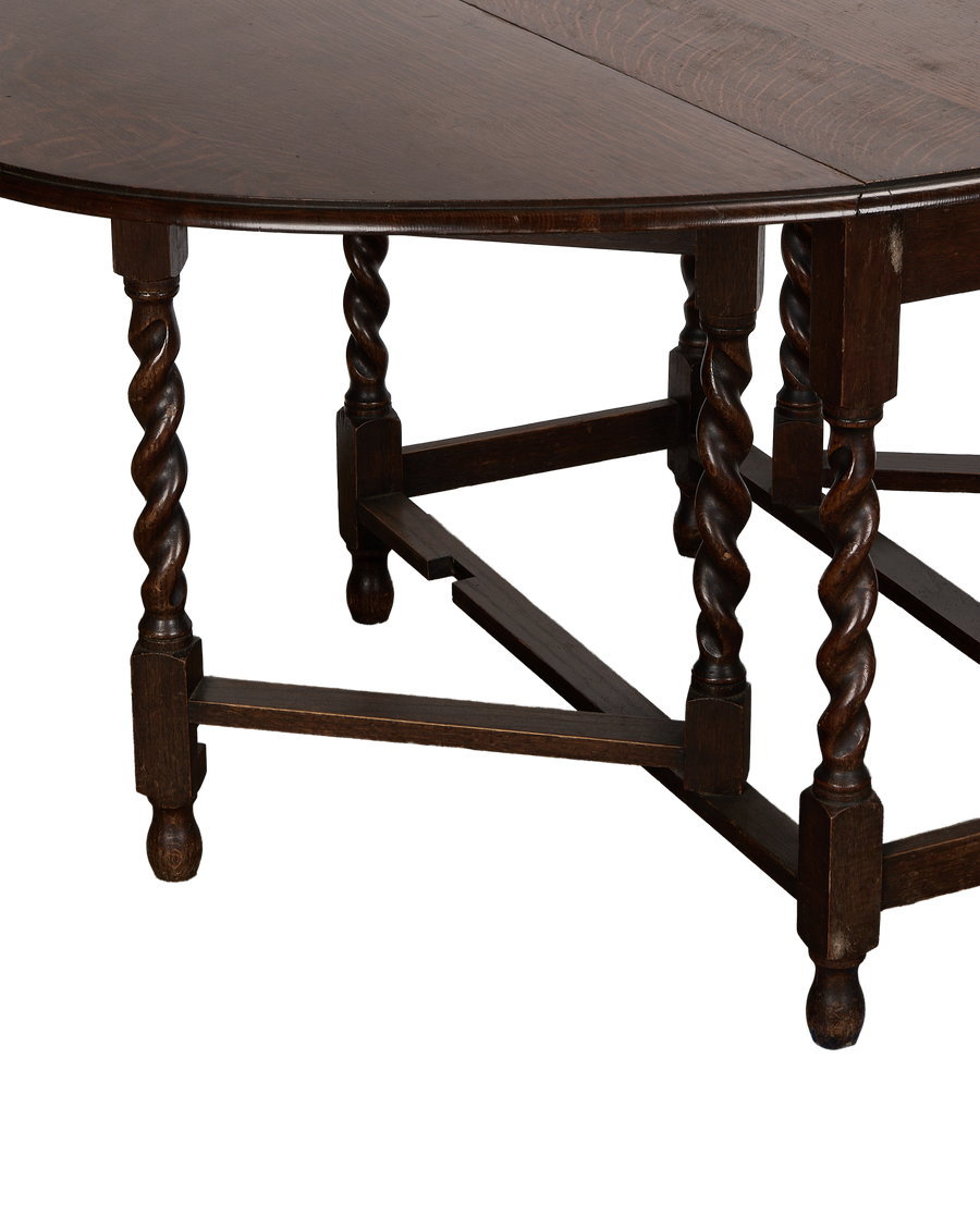 Vintage French oak gate leg table, showing ornate barley twist legs and side stretcher detail.
