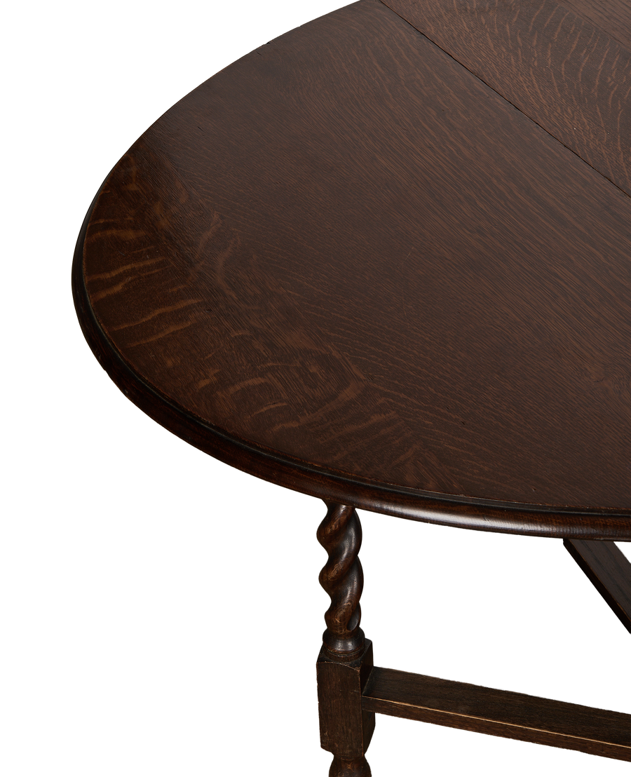 Vintage French oak gate leg table, showing a detailed view of its turned leg.
