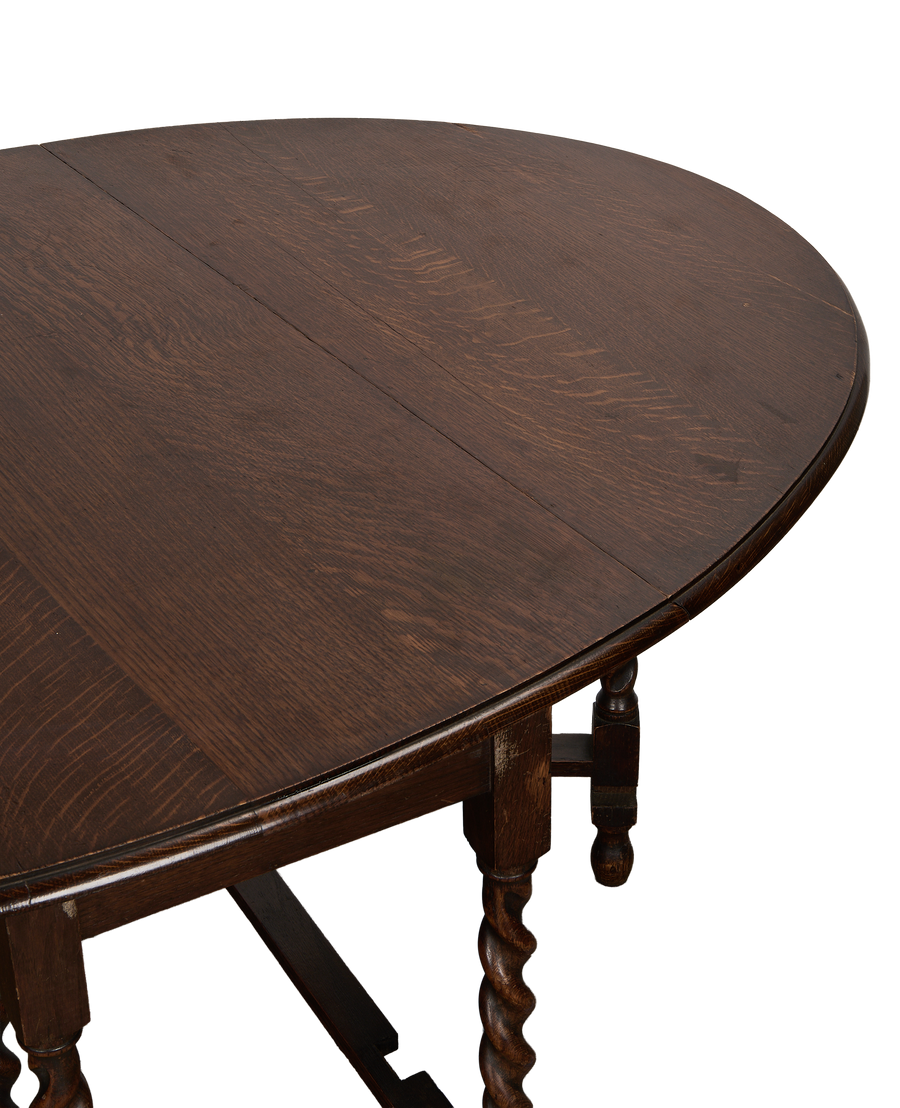Vintage French oak gate leg table, showing ornate barley twist legs and tabletop wood grain.