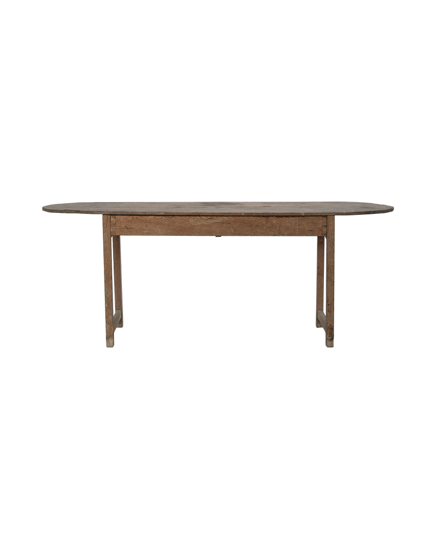 Vintage French oak oval dining table's full left-side view showing aged wood.