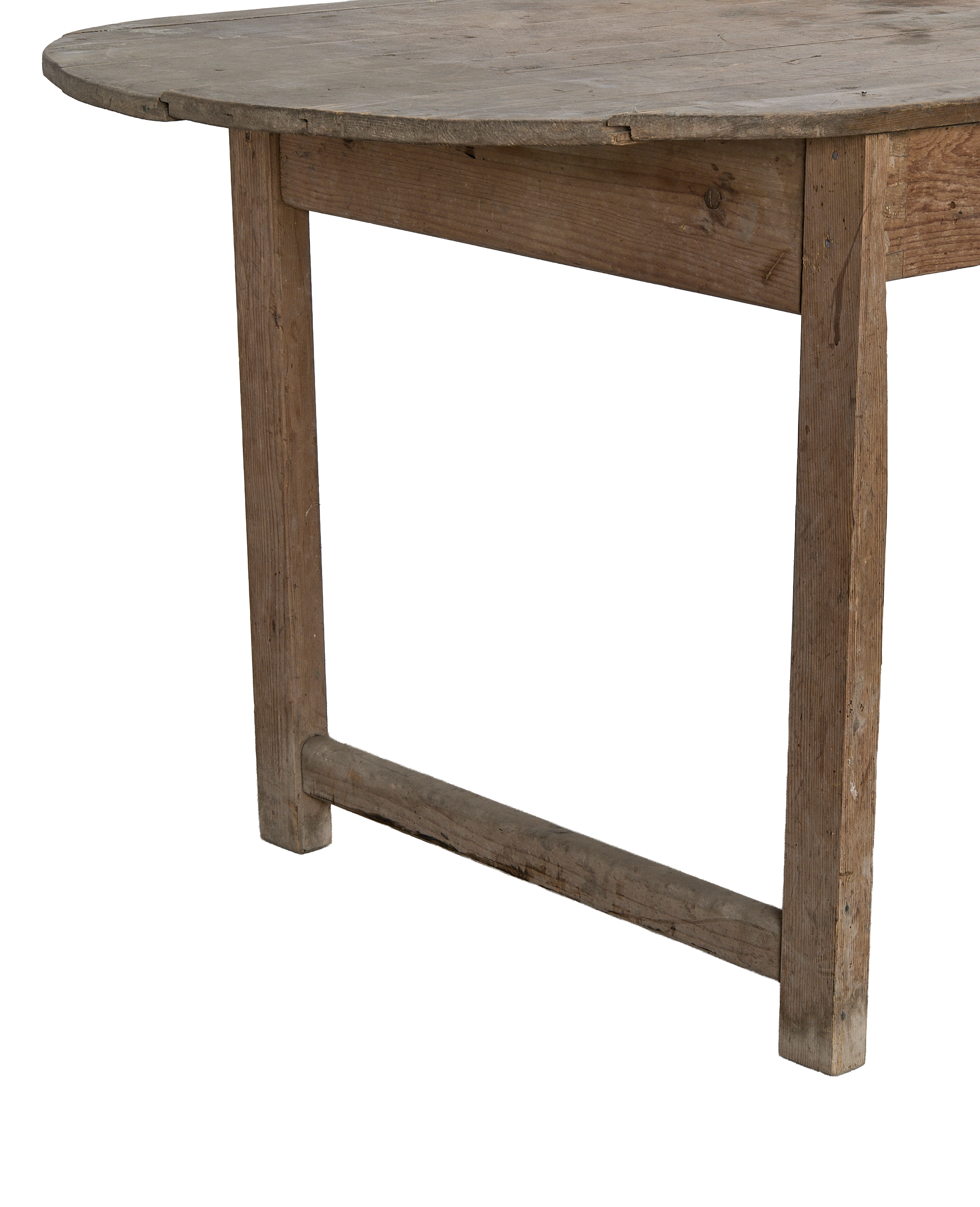 Vintage oak oval French dining table, showing rough wood texture and sturdy leg joinery.