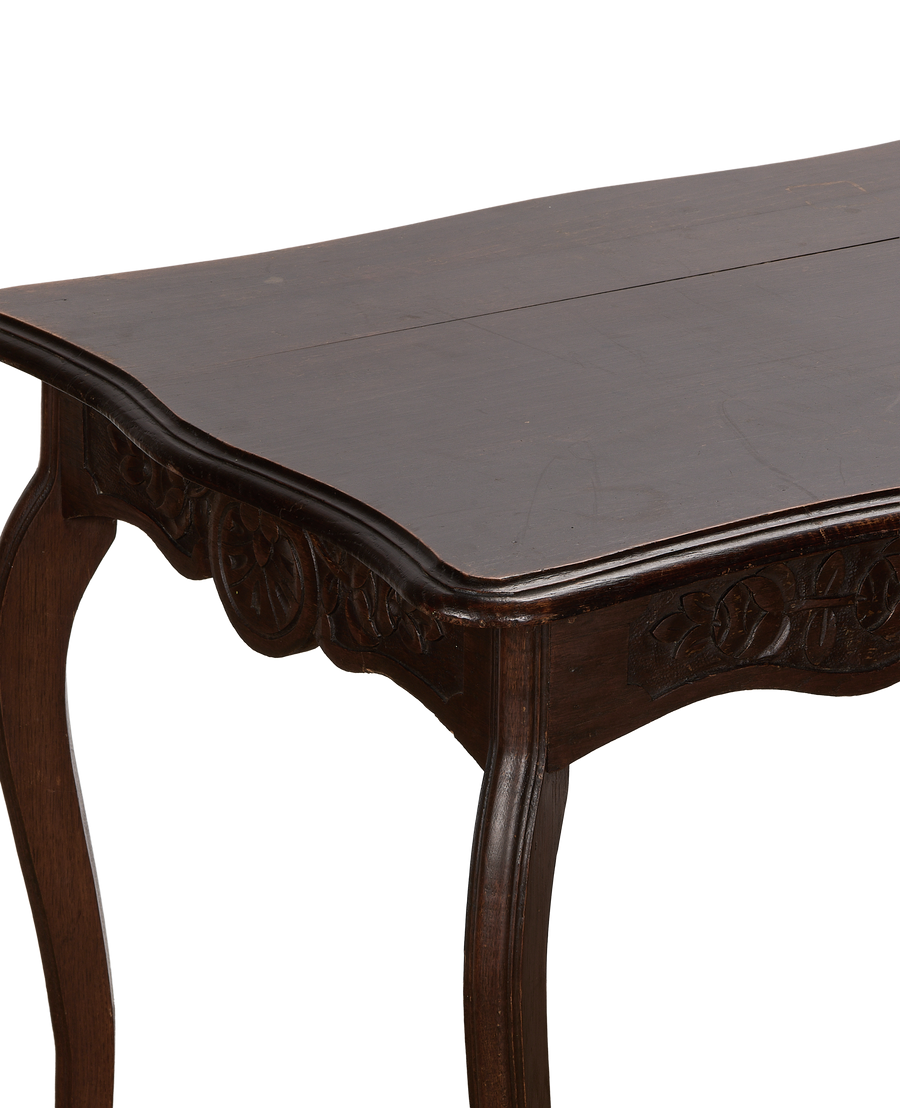 Vintage French oak decorative table, close-up of curved leg, ornate carved apron.