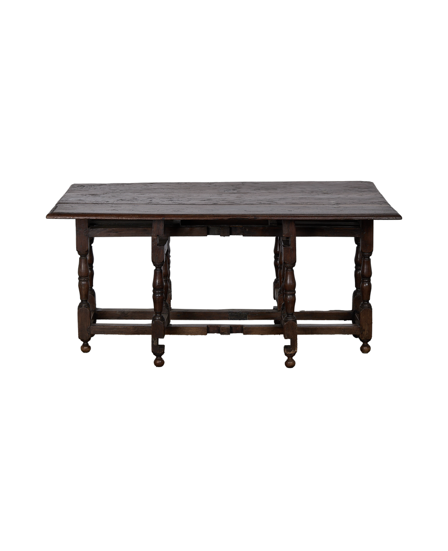 Vintage Spanish oak folding table, showing side view with unfolded leaves.