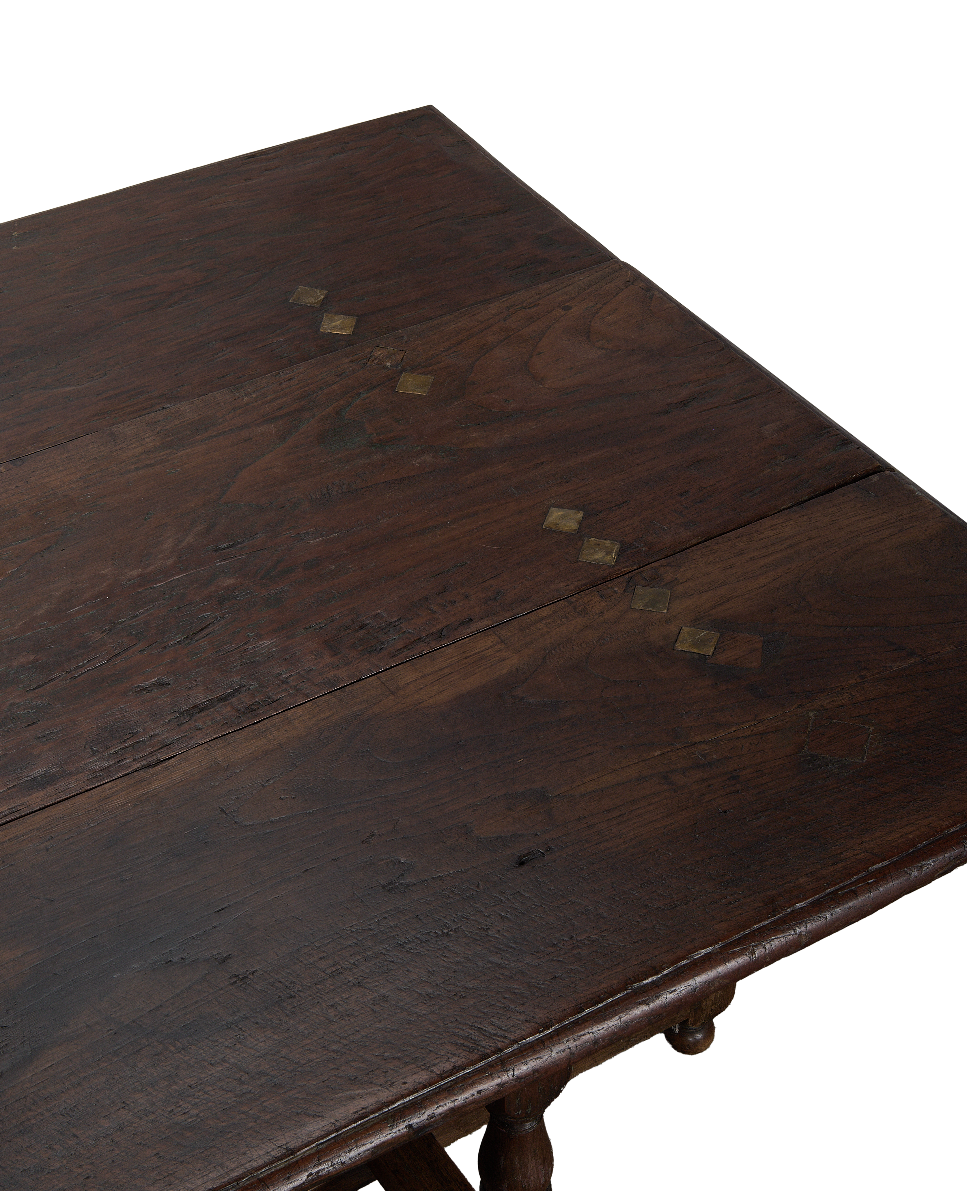 Vintage French oak folding table, close-up of dark distressed wood and brass diamond details.