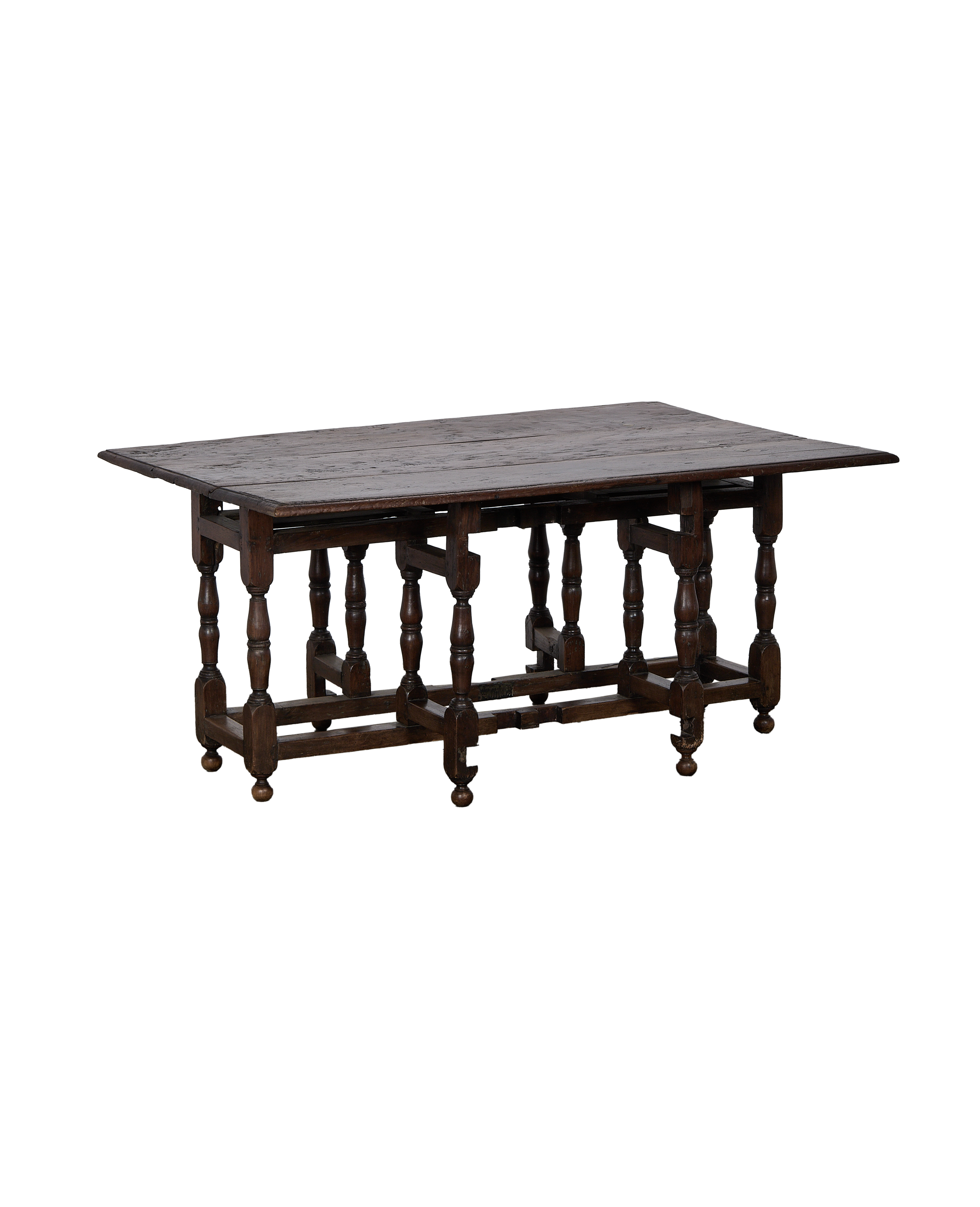 Vintage Spanish oak folding table with extended leaves, showcasing turned legs and rustic dark wood.
