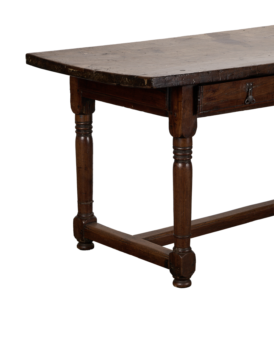 Antique French 18th-century oak drawer table, showing turned legs and distressed tabletop.