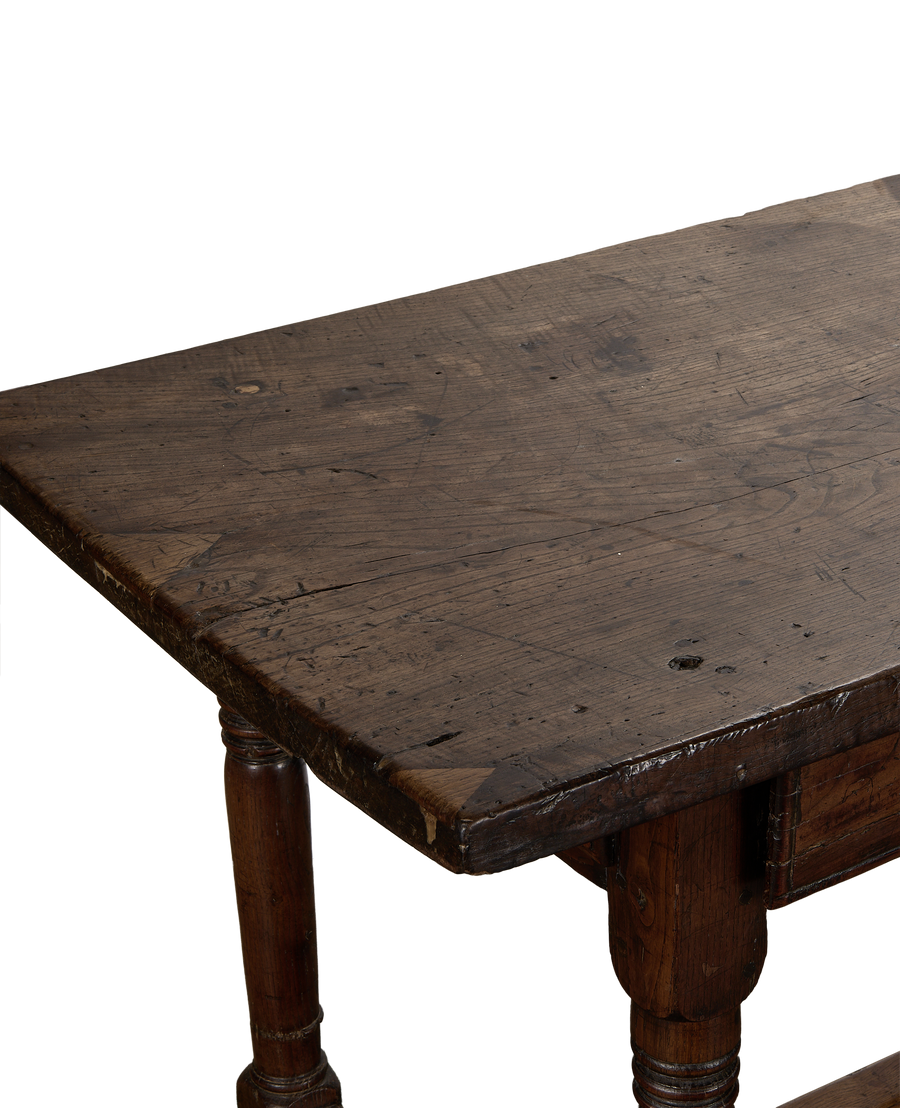 Close-up of antique 18th Century French oak drawer table top showcasing distressed patina.
