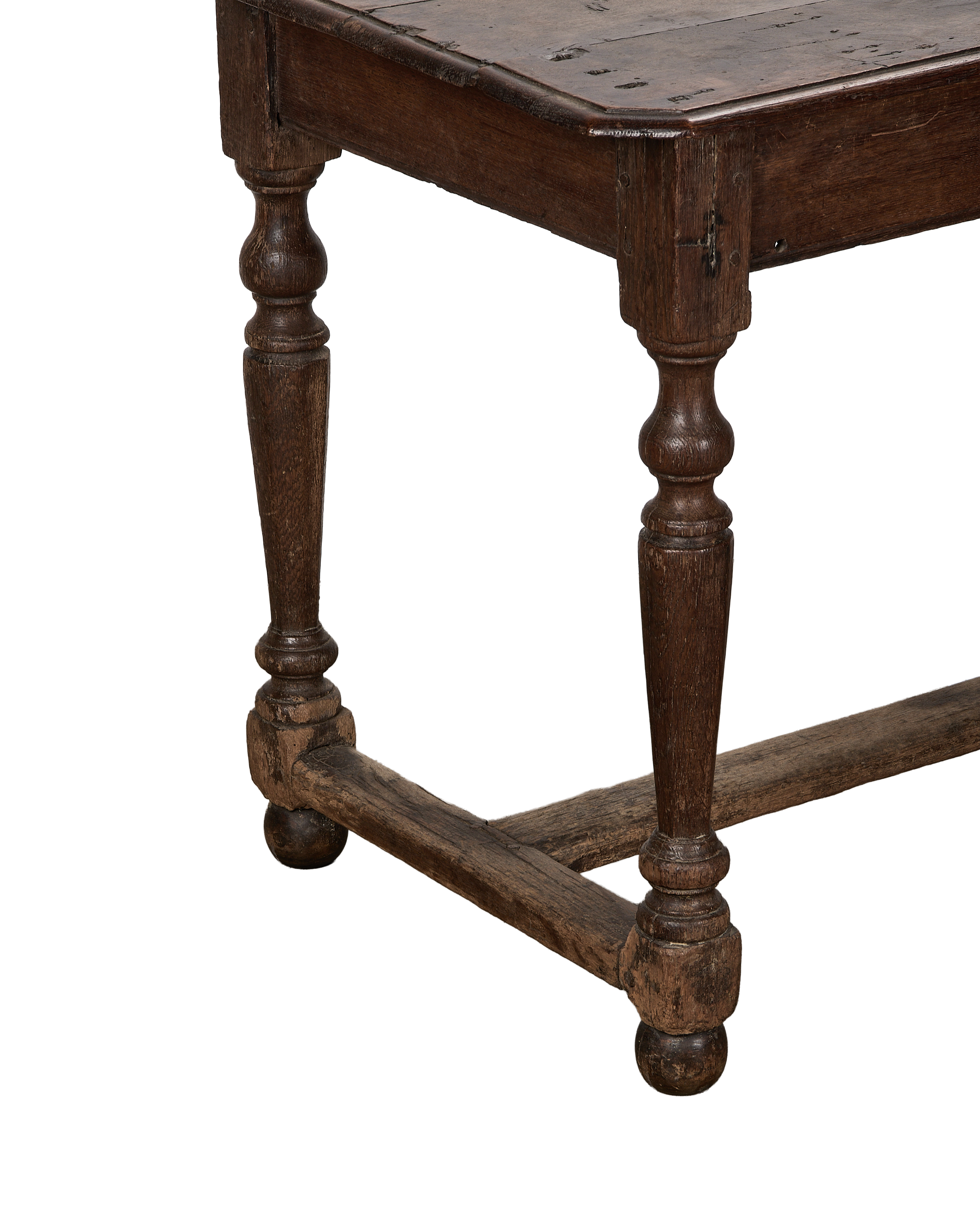 Vintage French oak console table showing the carved, turned legs, stretcher, and distressed top.