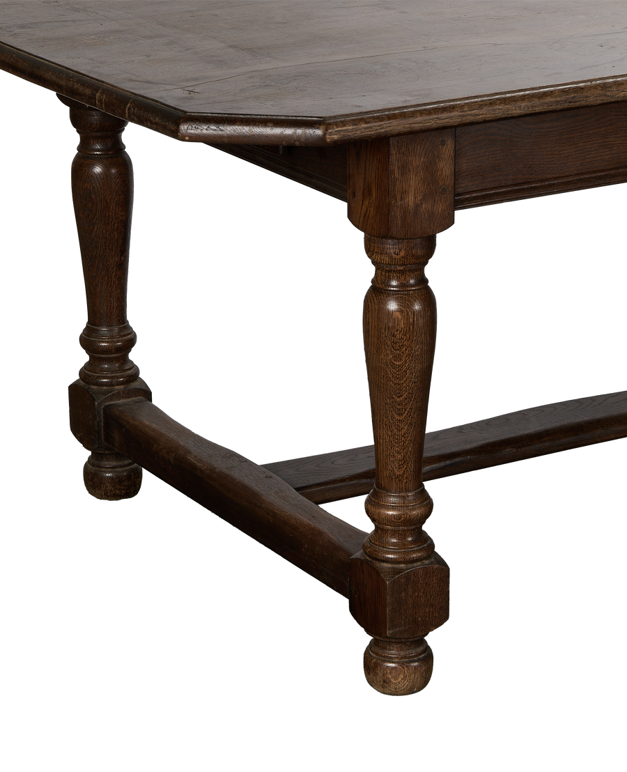 Vintage French oak dining table leg, showing turned detail and stretcher base.