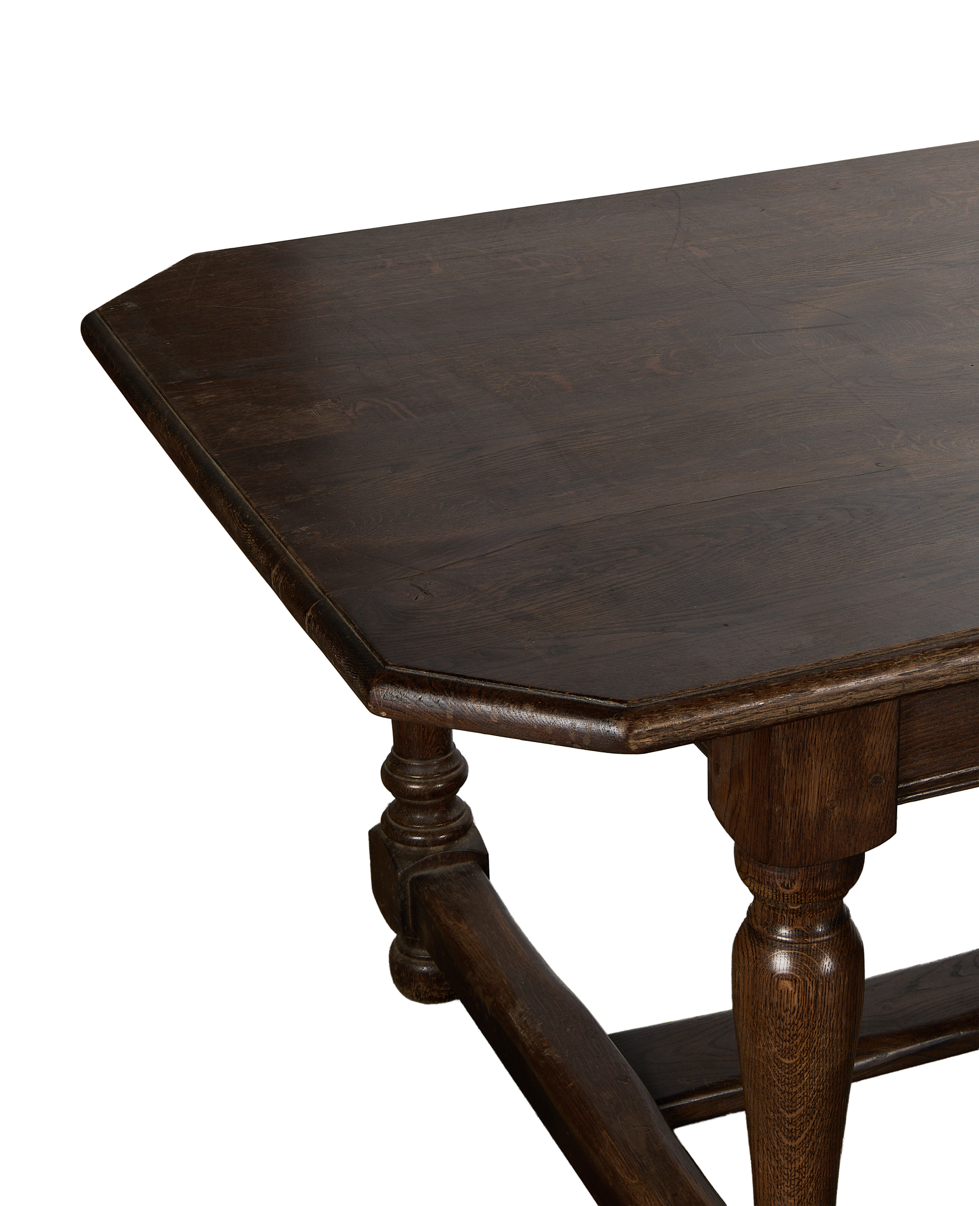 Octagonal vintage French oak Drapers Dining Table top surface close-up, turned leg detail.