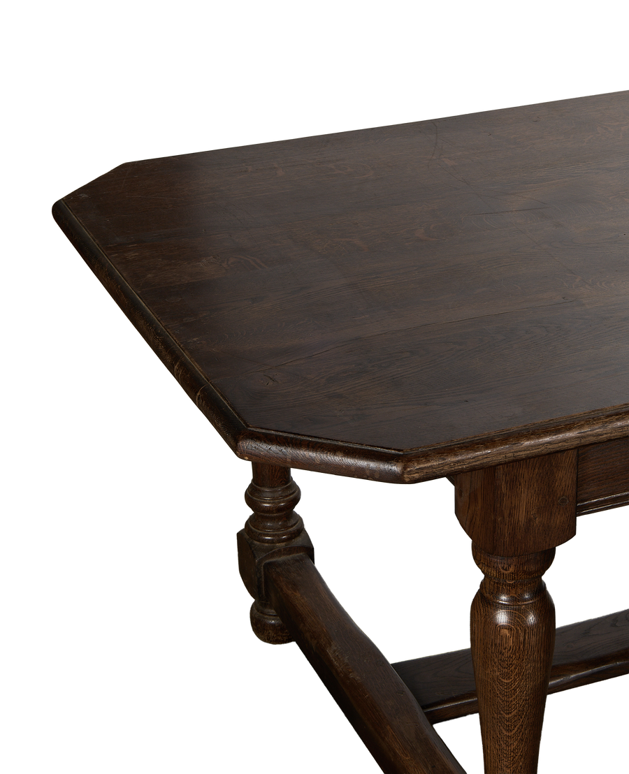 Octagonal vintage French oak Drapers Dining Table top surface close-up, turned leg detail.