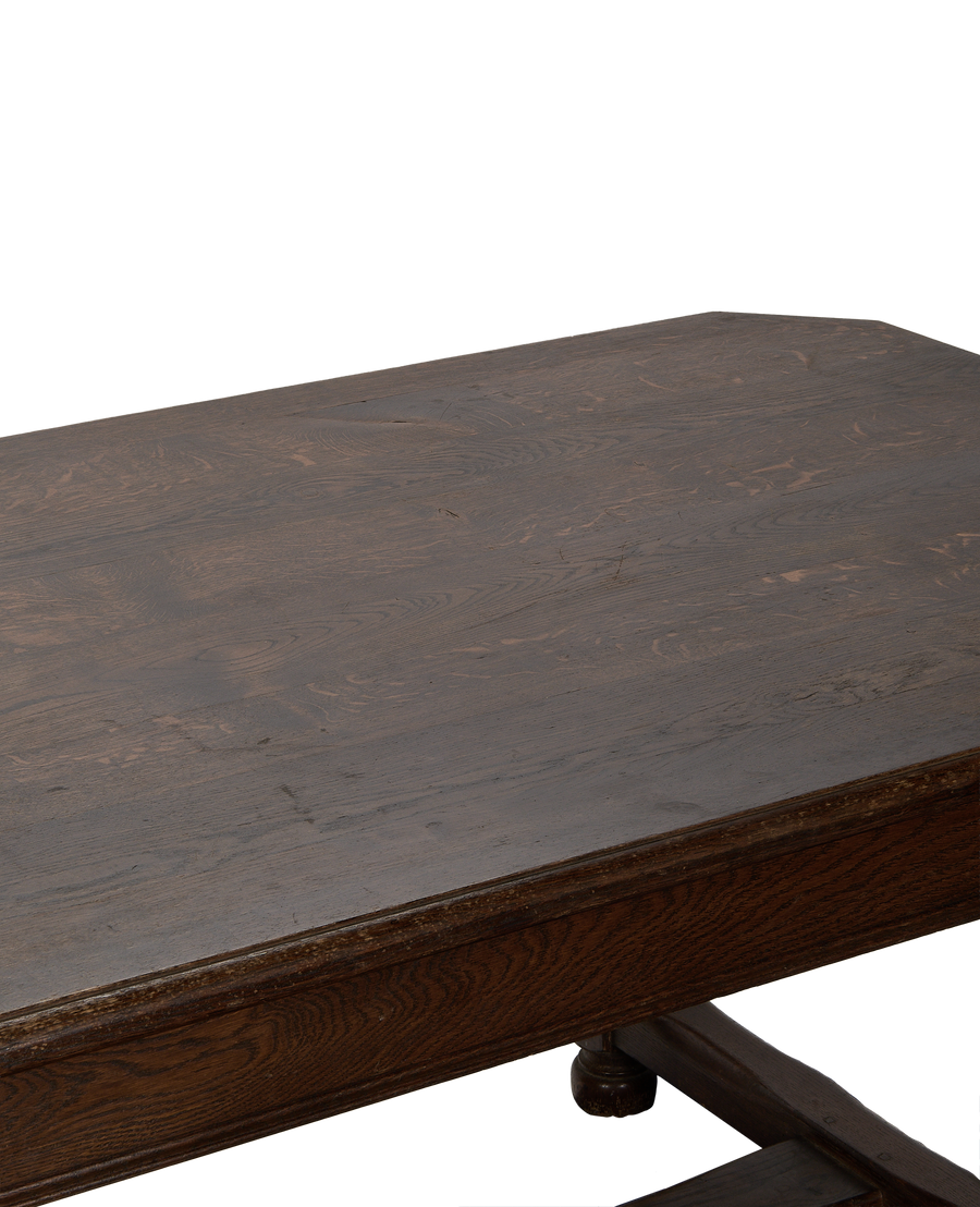 Close-up of vintage French oak dining table surface, showcasing distressed wood grain detail.