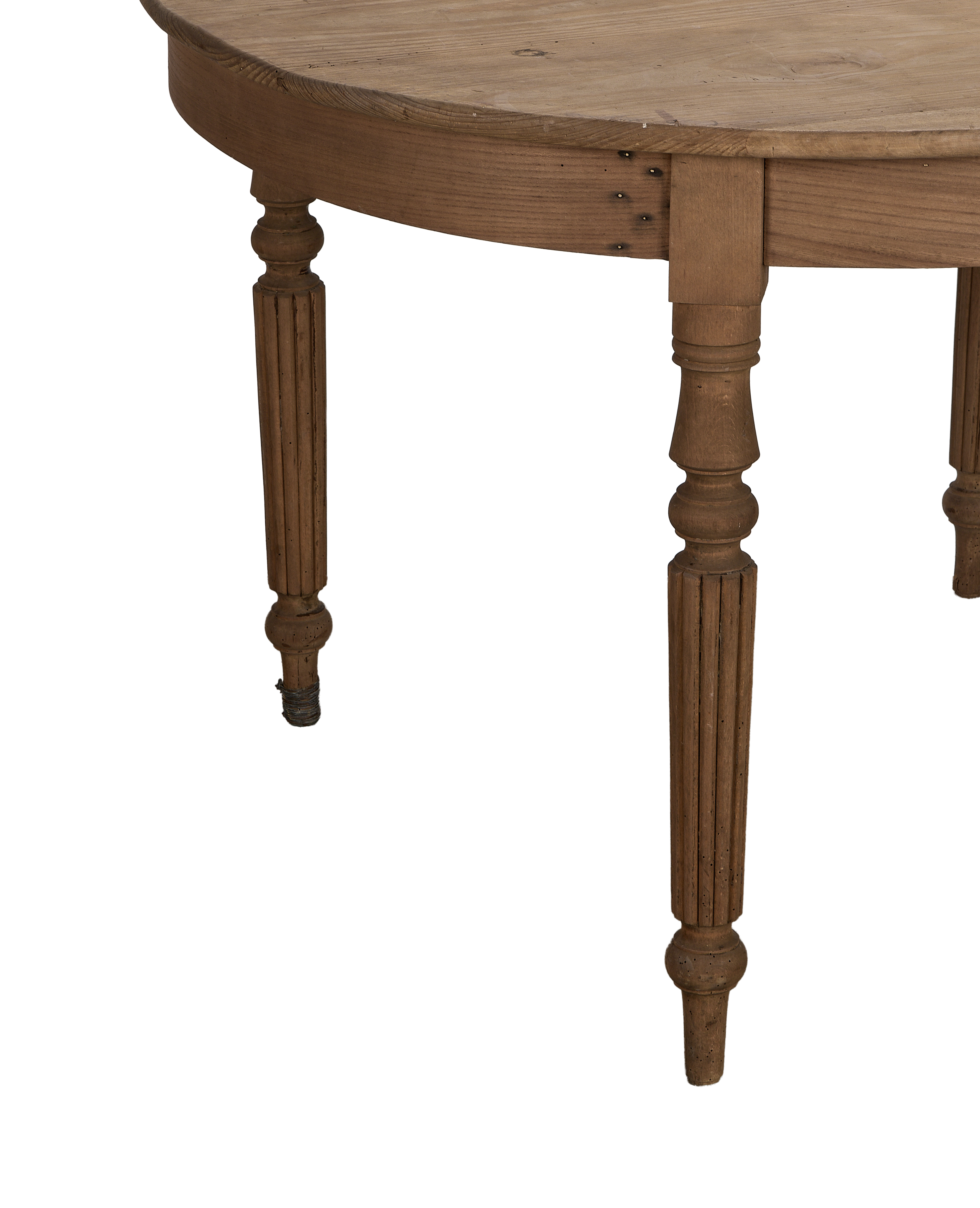 Vintage French oak farmhouse dining table: close-up of fluted turned wooden legs and apron.