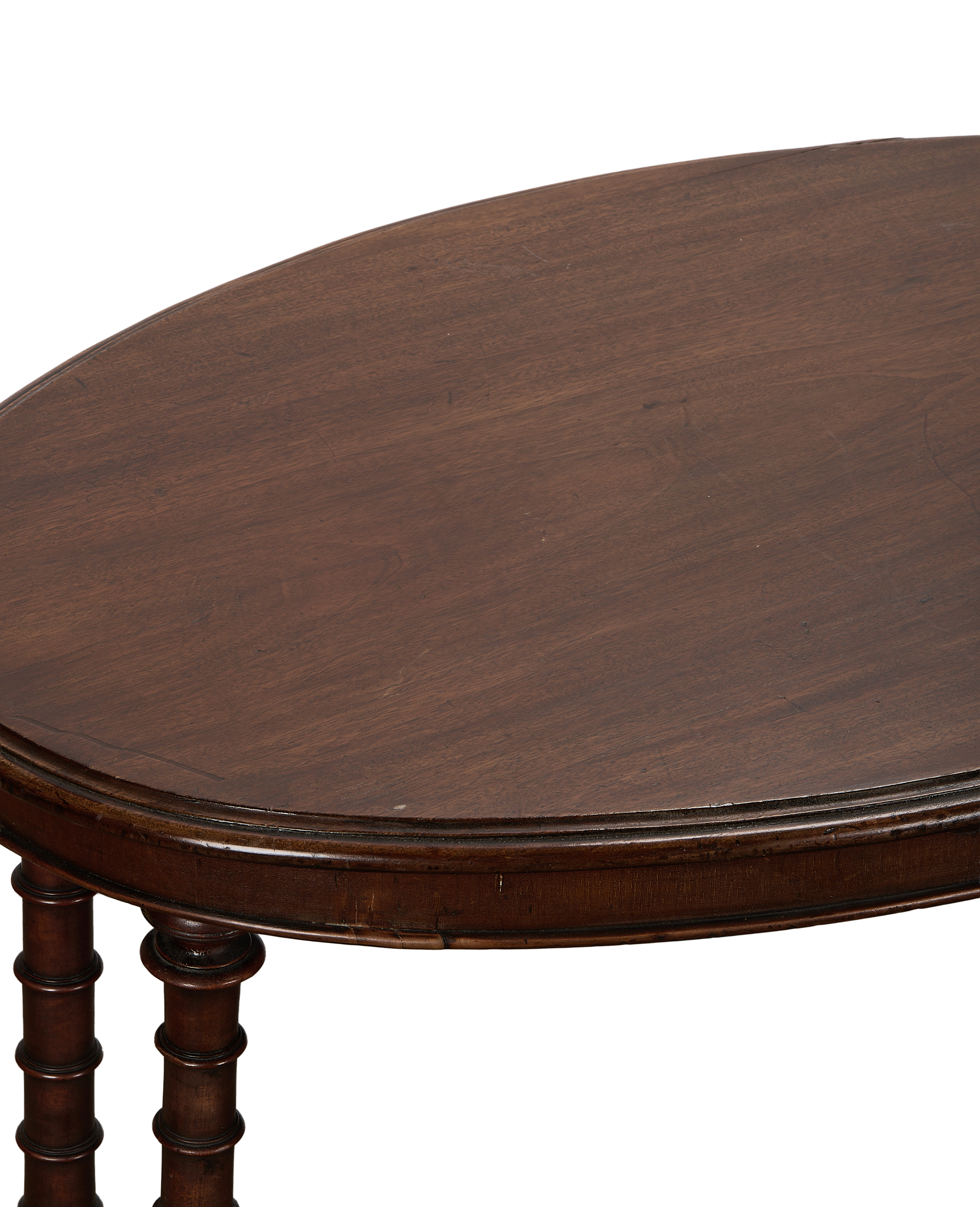 Vintage French oval oak entry table, detailed close-up of dark wood top and turned legs.