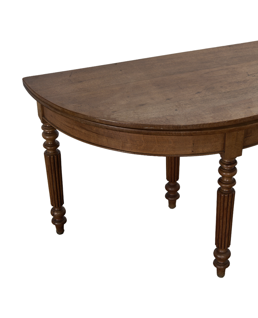 Vintage French oak demi-lune folding table, showing detailed fluted and turned legs.