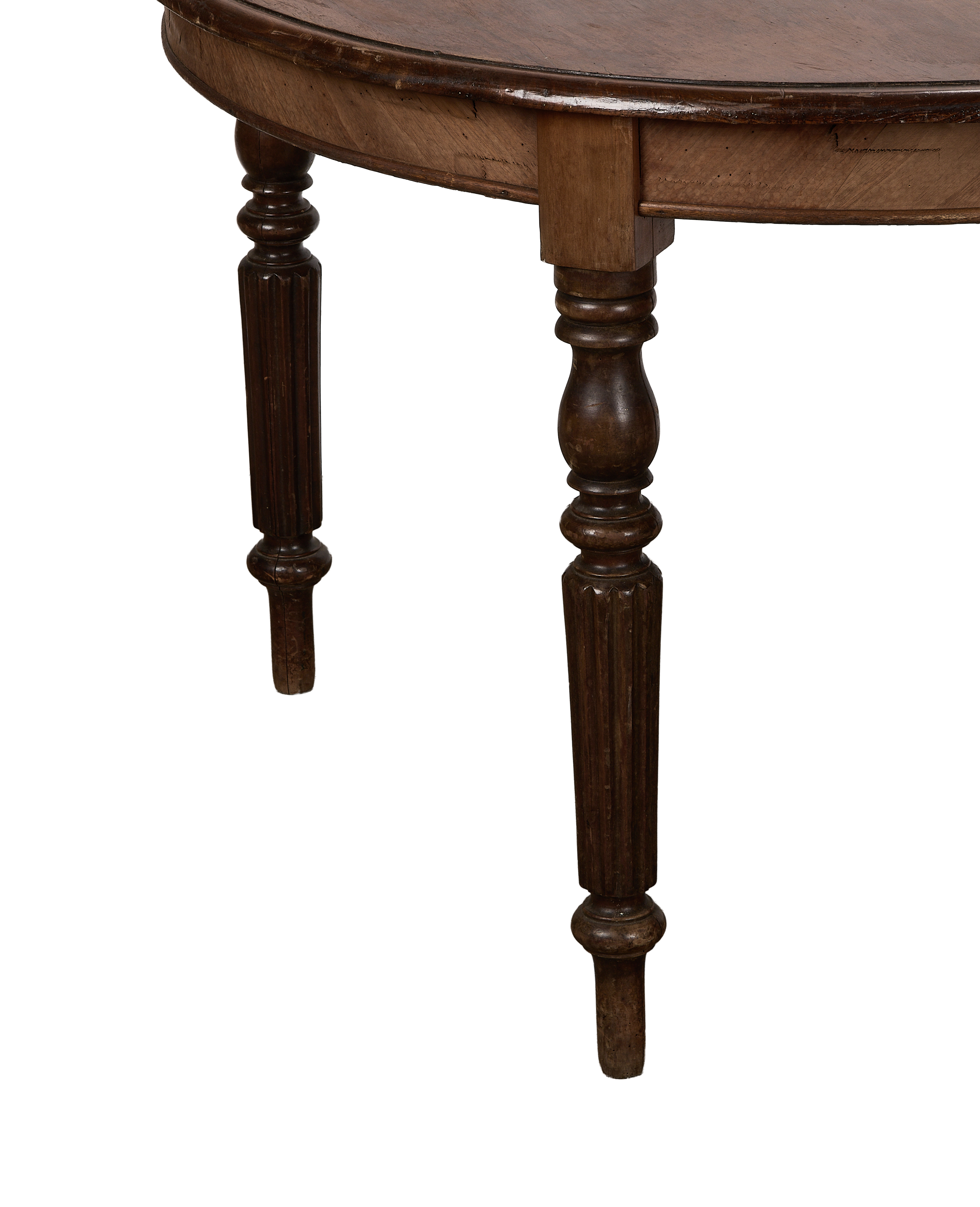 Close-up of vintage French oak round dining table legs, fluting detail, and apron.