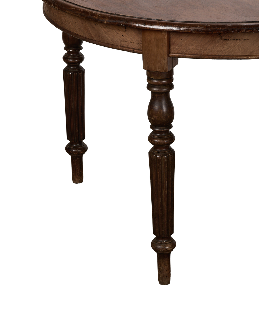 Close-up of vintage French oak round dining table legs, fluting detail, and apron.