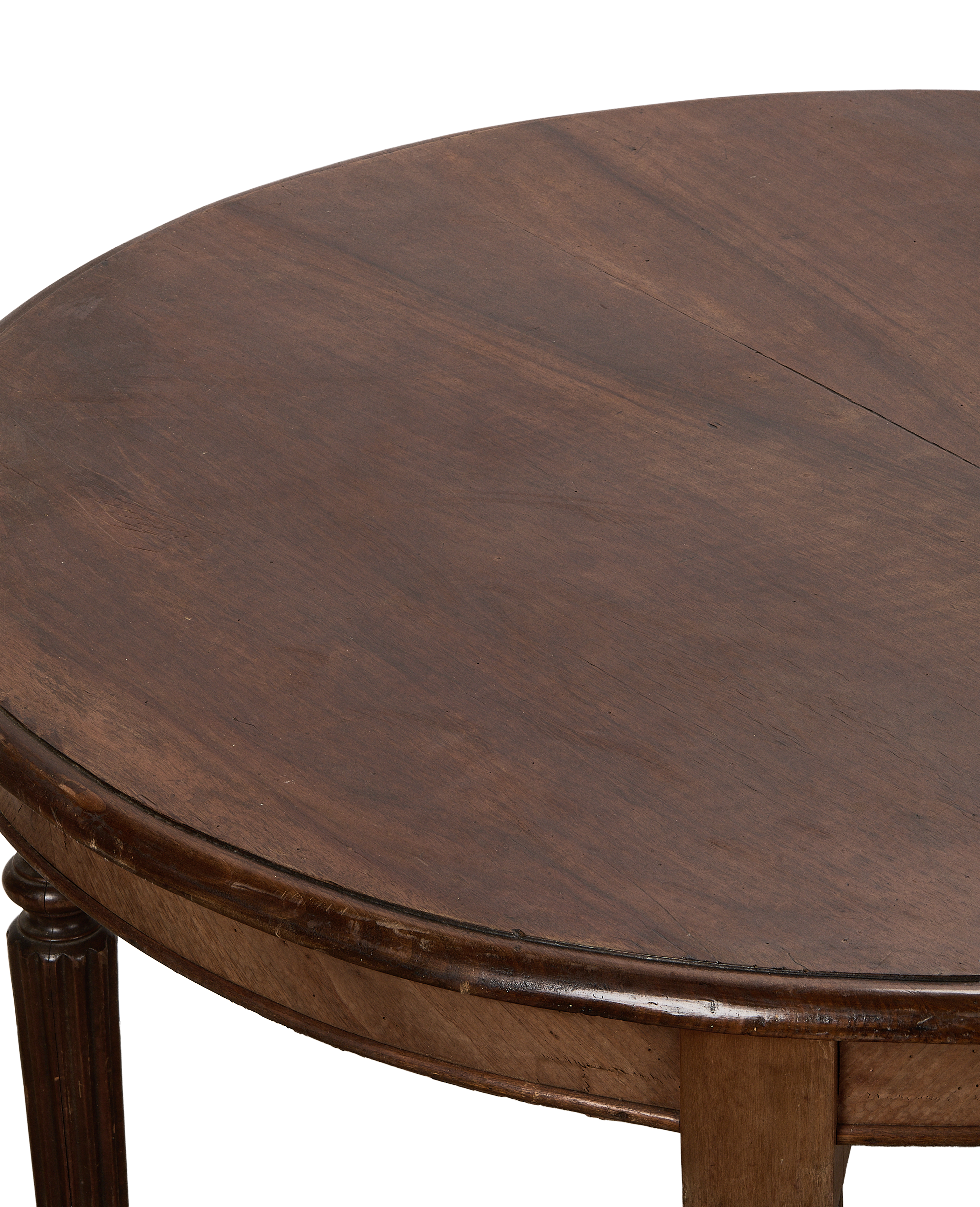 Vintage oak round dining table surface, close-up of dark wood grain with seam.
