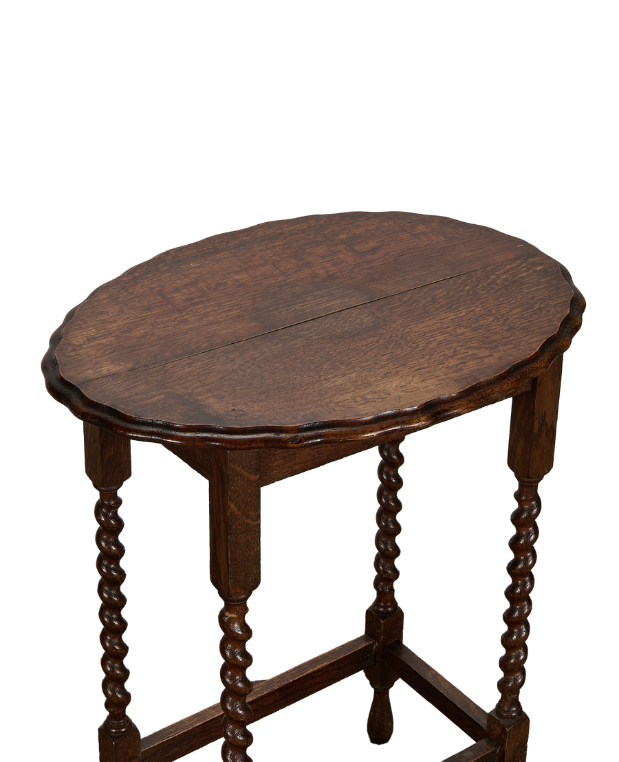Vintage French oak barley twist table, showing carved scalloped edge and tabletop grain.