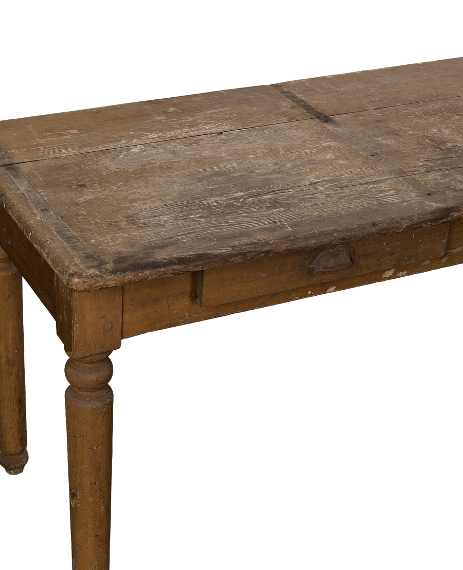 Vintage distressed oak monastery table with an ornate carved leg and rough patina.