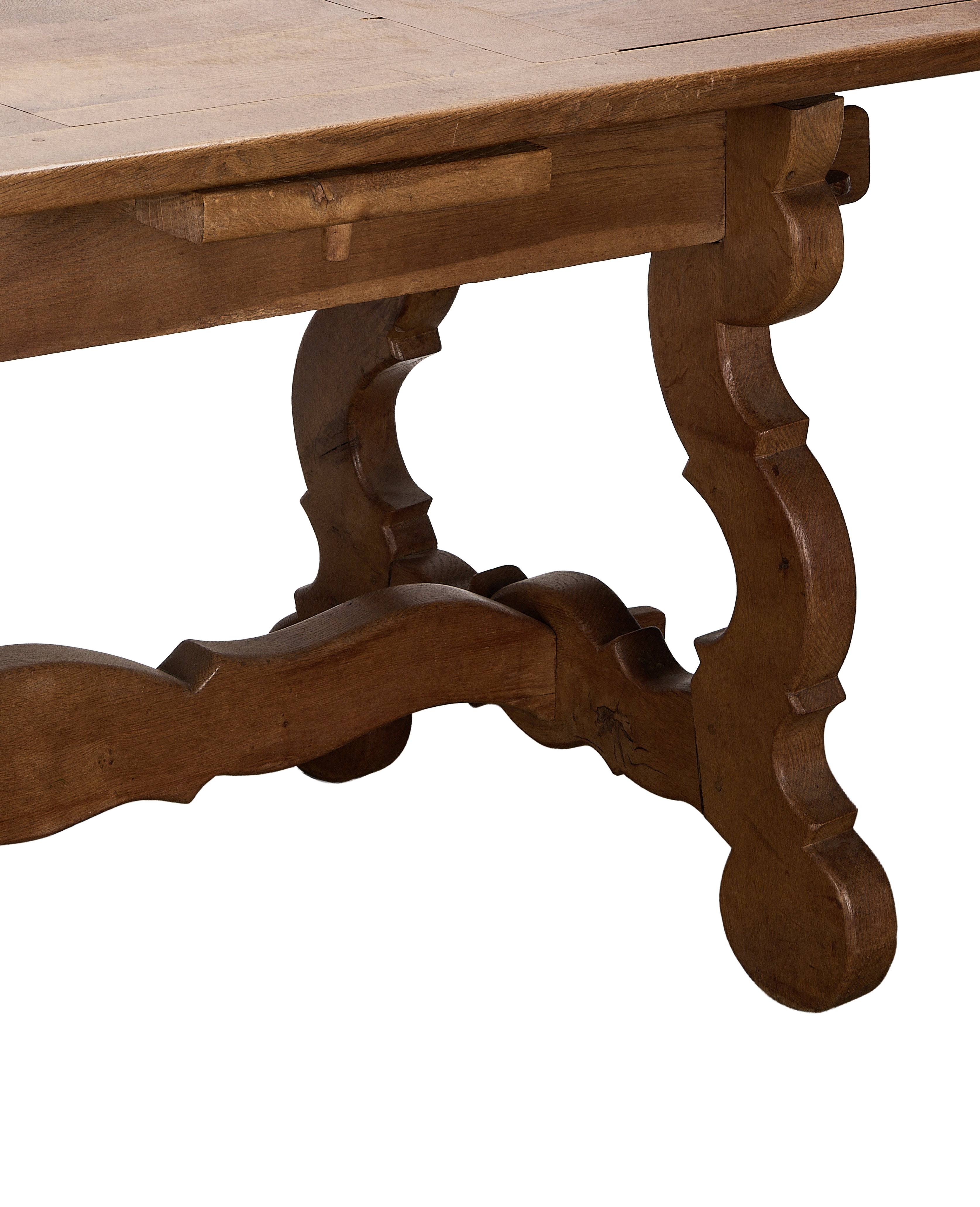 Vintage French oak refectory table, showing extendable leaf supports and scrolled trestle base.