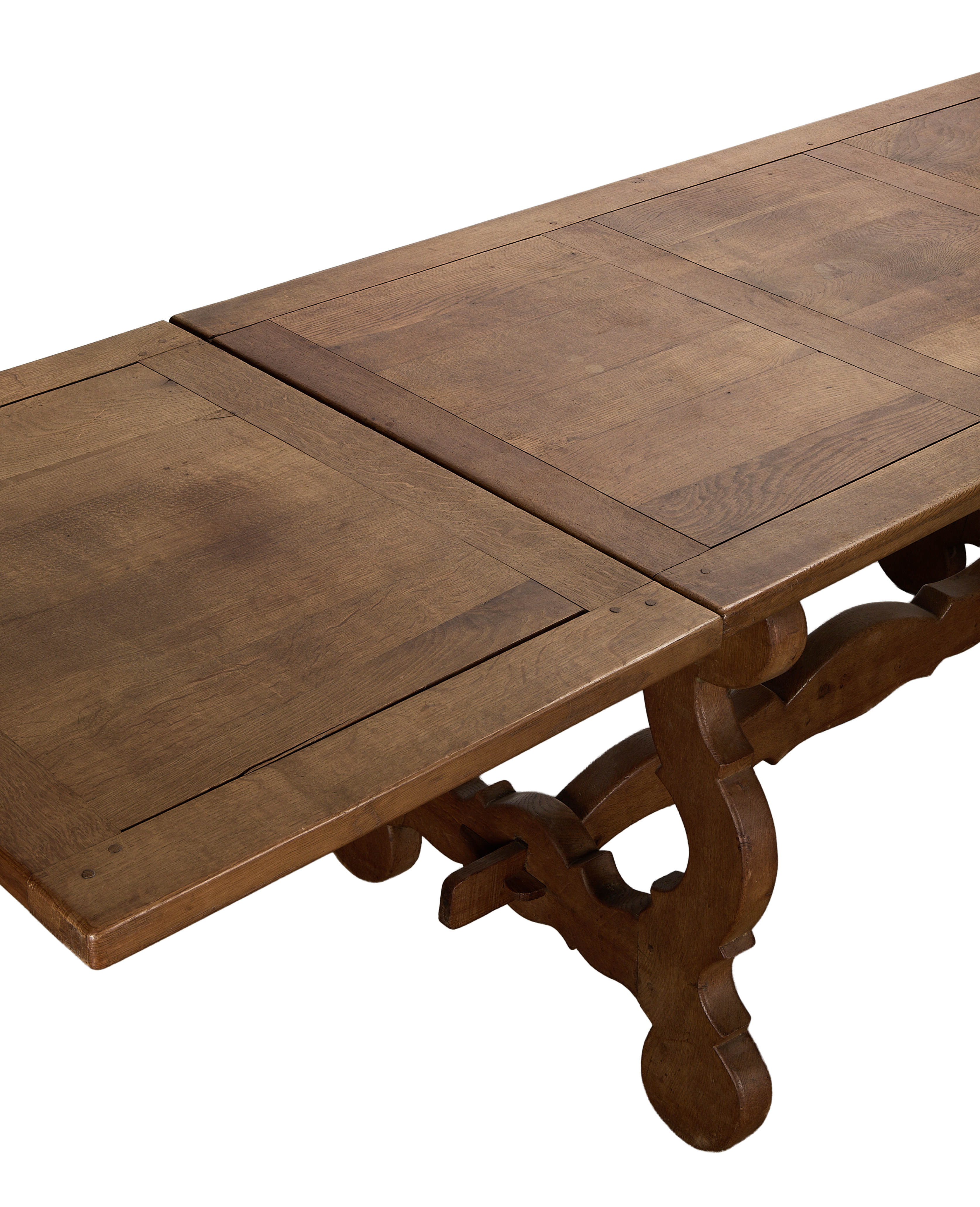 Vintage French oak refectory dining table with original extended leaves and scrollwork.