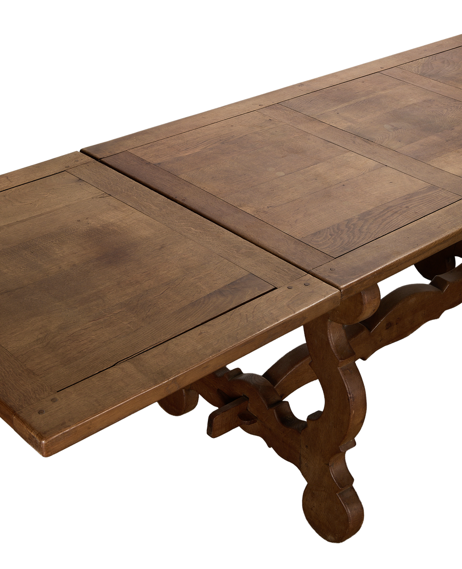 Vintage French oak refectory dining table with original extended leaves and scrollwork.