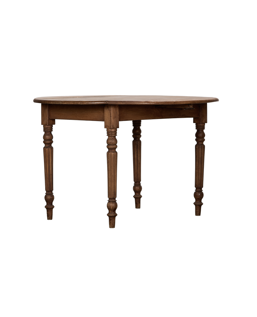 Vintage French oak drop leaf table, closed position, showing turned fluted legs.