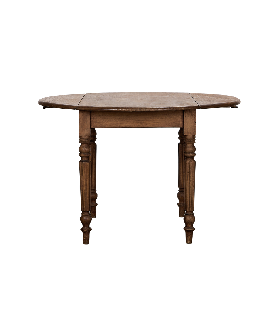 Vintage French oak drop leaf table, leaves up, showcasing aged wood grain.