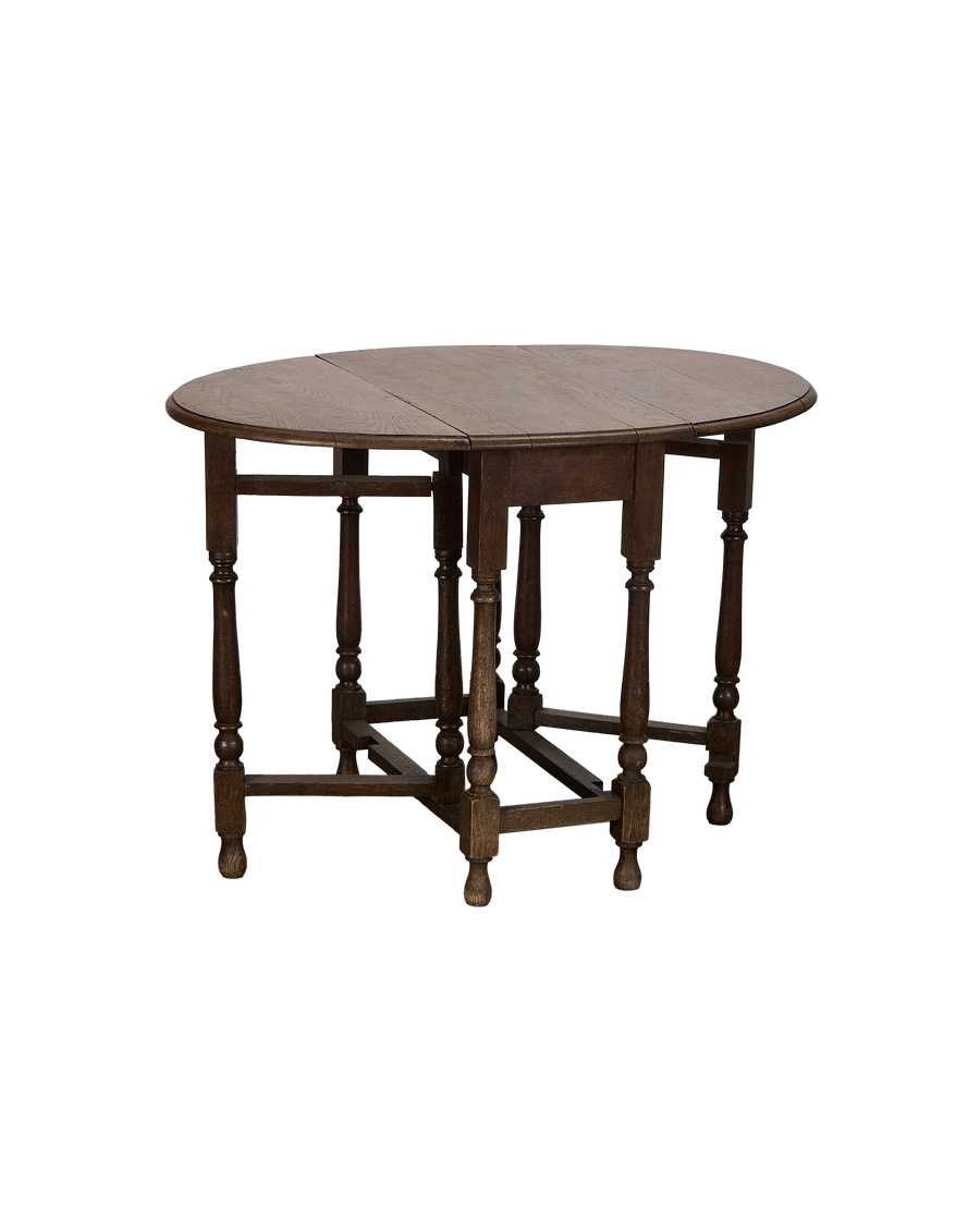 Vintage French oak drop leaf gate leg table, showing lower stretcher details and turned legs.