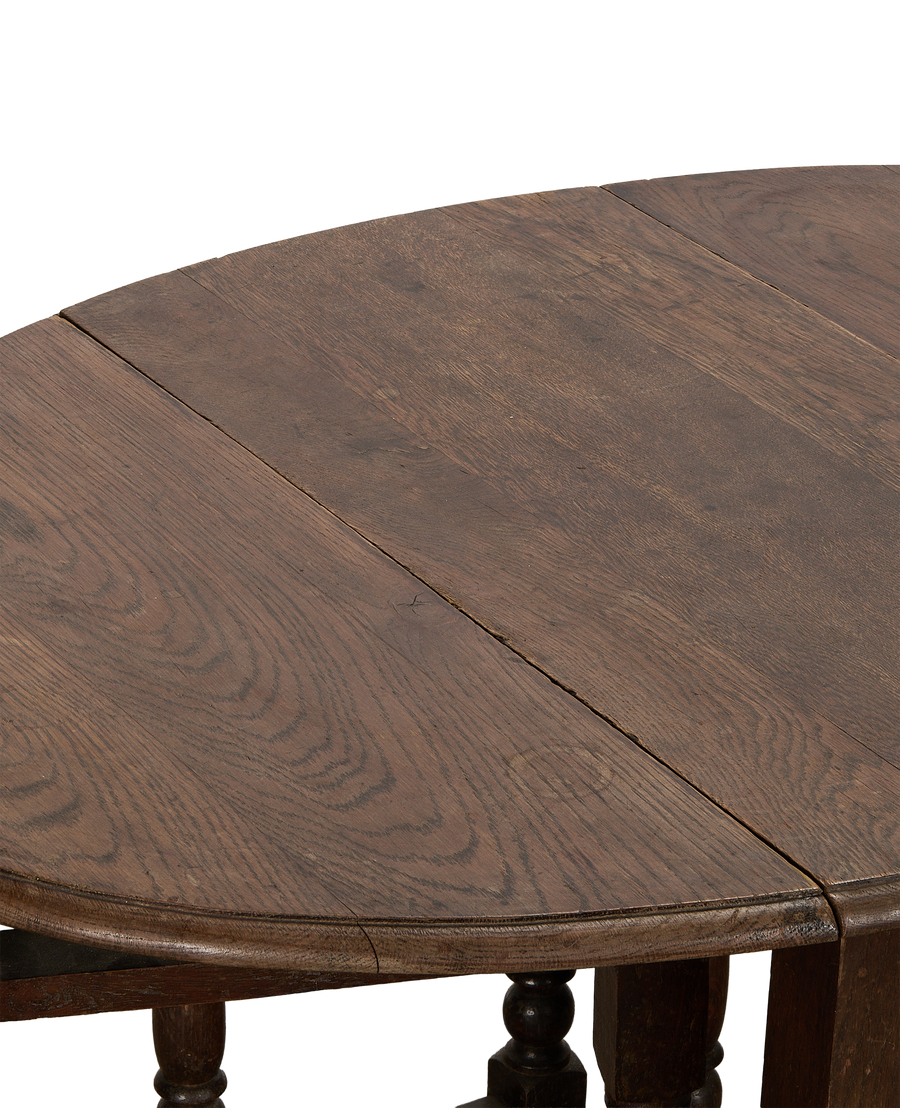 Vintage French oak drop gate leg table, close-up showing tabletop's aged wood grain.