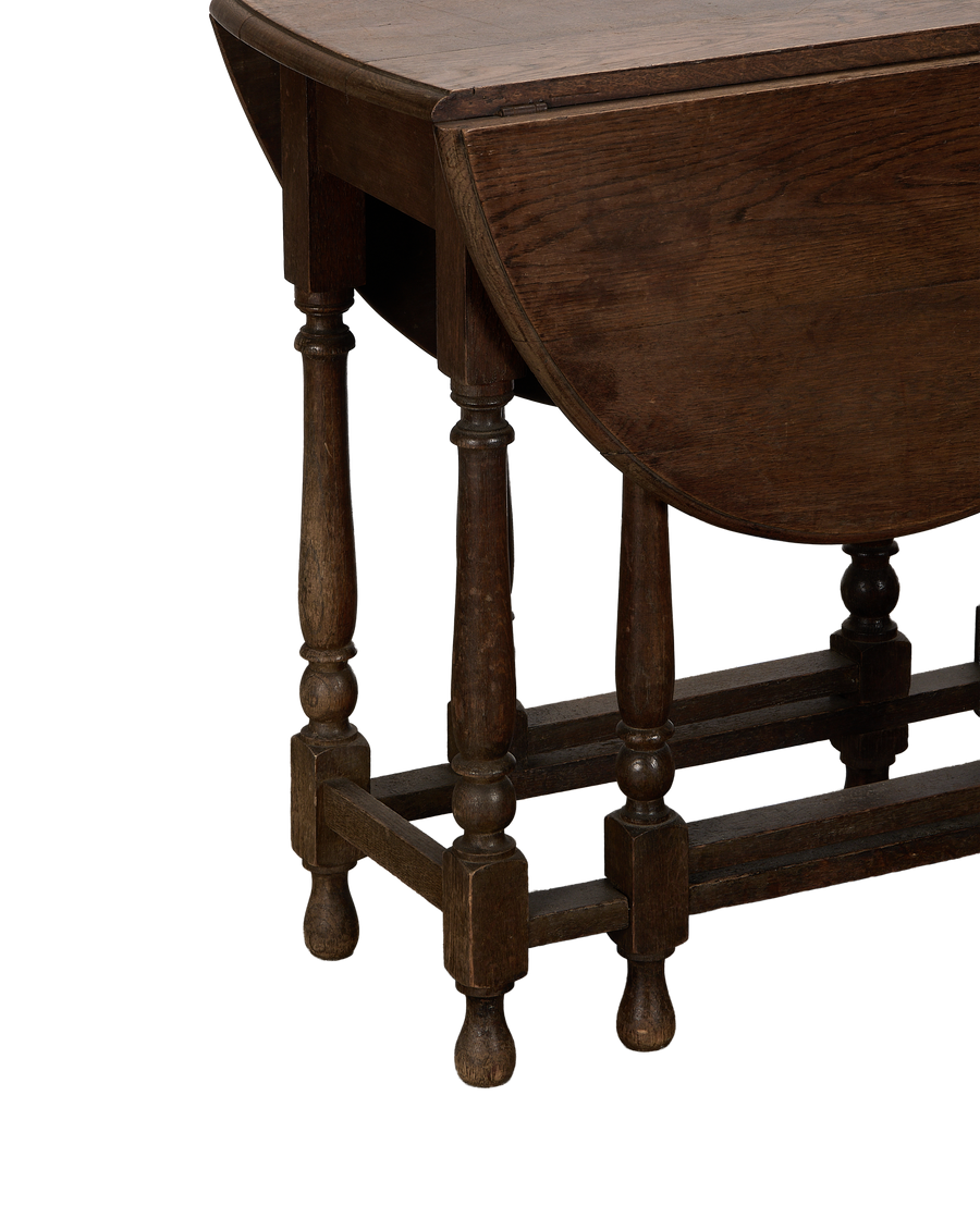 Vintage French oak Drop Gate Leg table, showing folded leaf and turned legs.