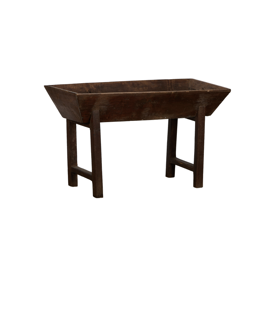 Vintage French oak Petrin table, showing angled view of rustic trough and distressed wooden legs.